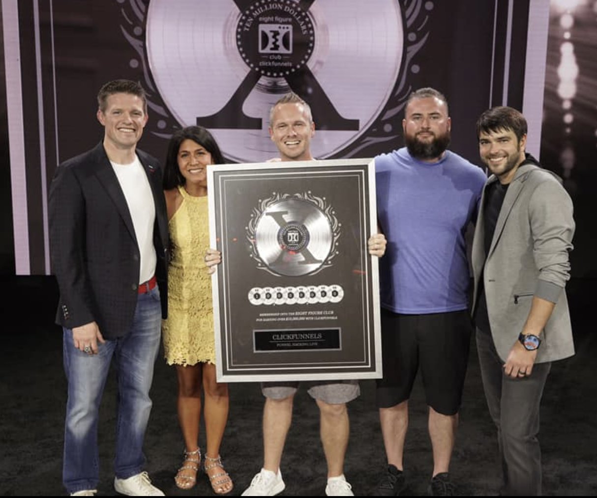 Be Top Local team accepting the ClickFunnels Two Comma Club X Eight Figure Award