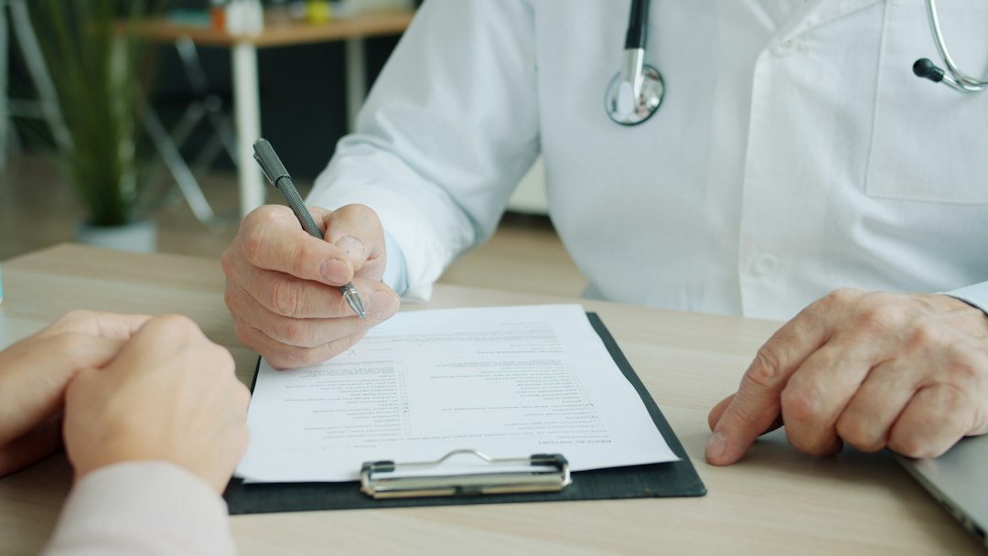 Woman reviewing functional medicine labs and blood work results at a table with practitioner