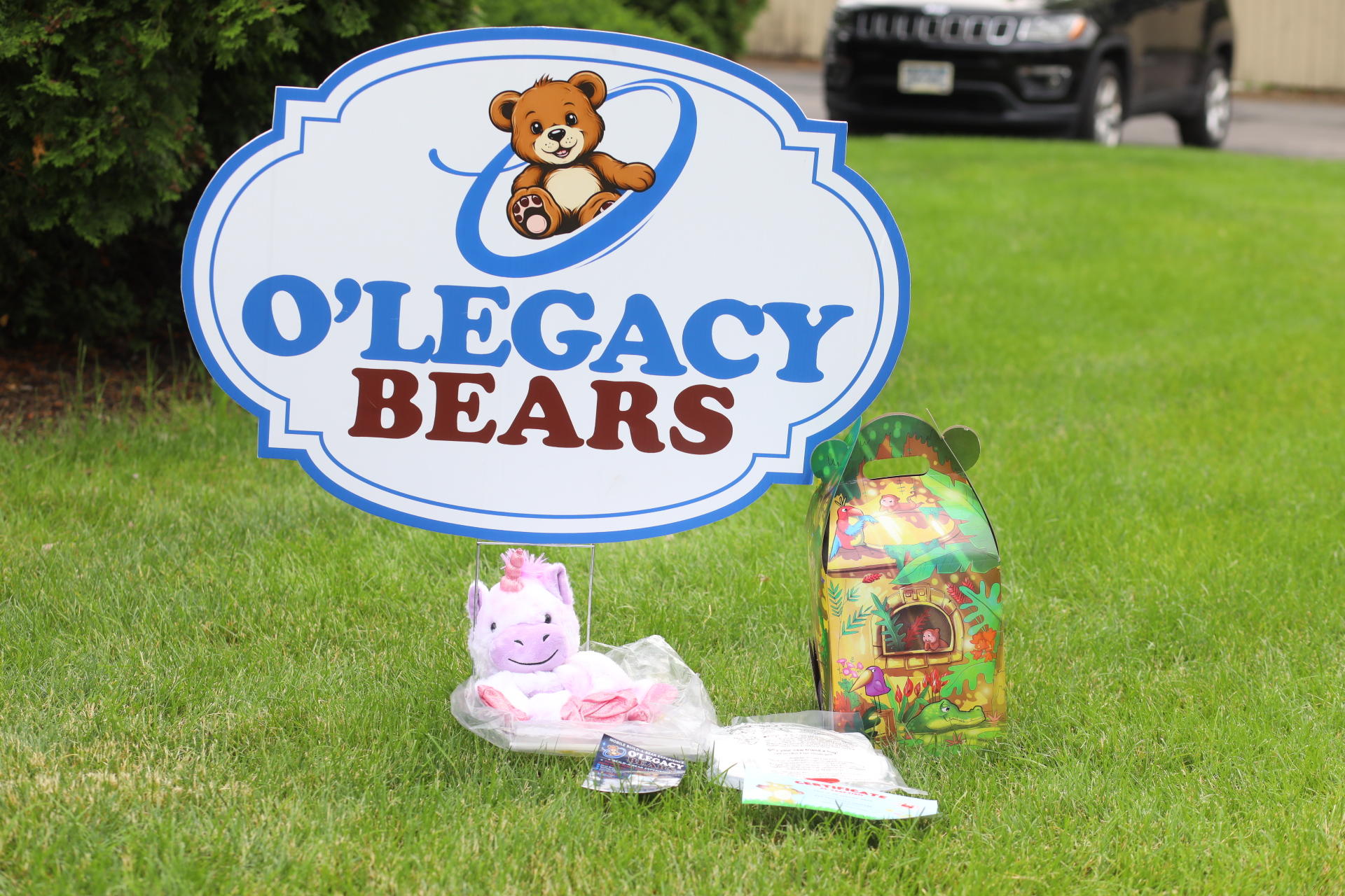 Unicorn plush kit displayed beneath the O’Legacy Bears sign