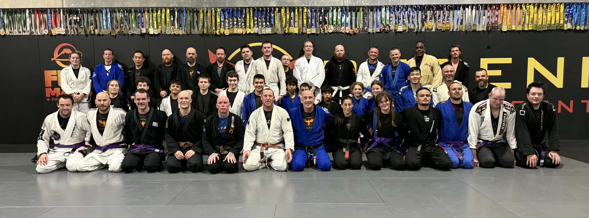 Phoenix Training Centre full team group photo with trophy wall