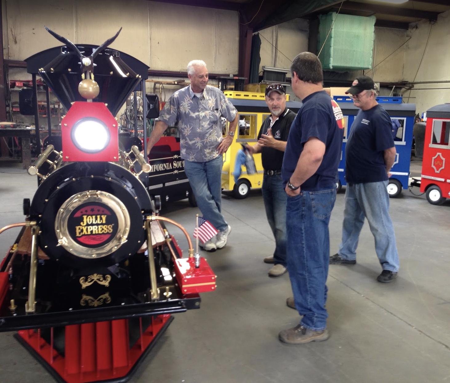 Michael and a group reviewing the Jolly Express train during its building process