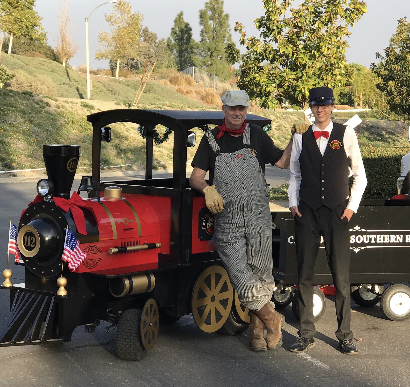 Michael with his grandson beside the Jolly Express Trackless Train