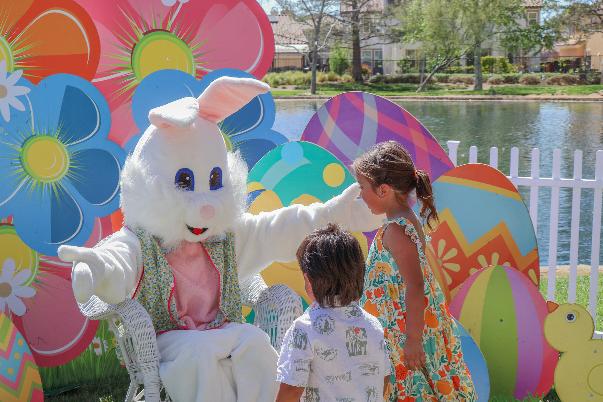 Children visiting a Bunny character with an Express Events spring photo backdrop