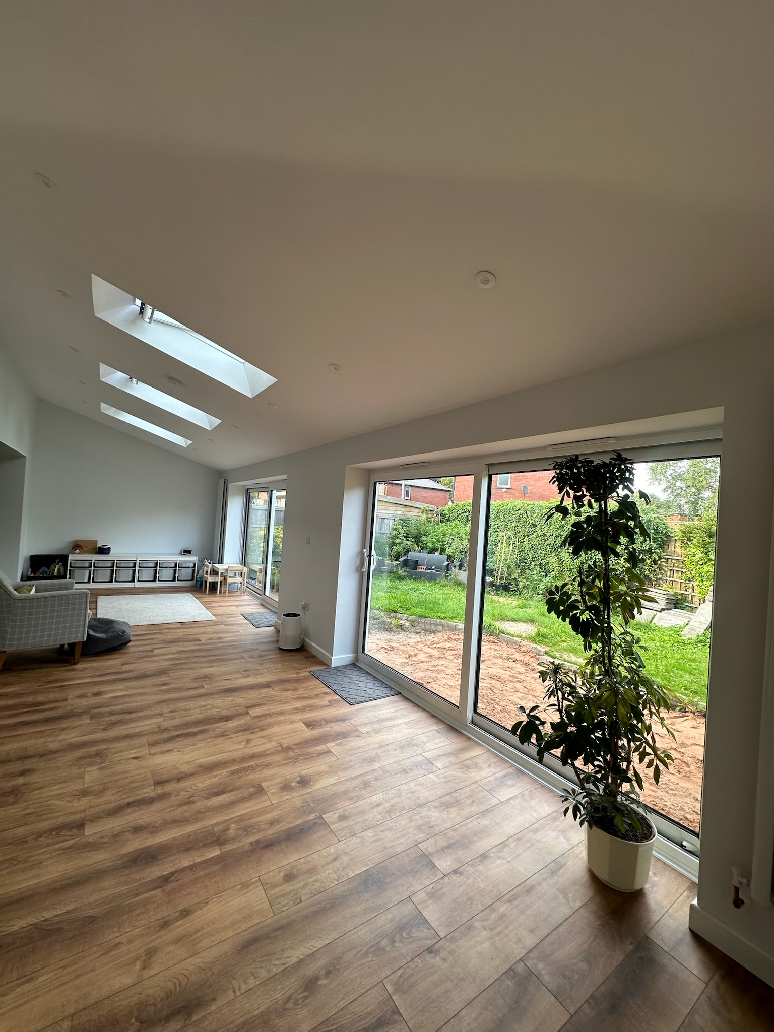 Modern rear house extension in Radcliffe with large sliding patio doors, roof skylights and open plan family living space Modern rear house extension in Radcliffe with large sliding patio doors, roof skylights and open plan family living space