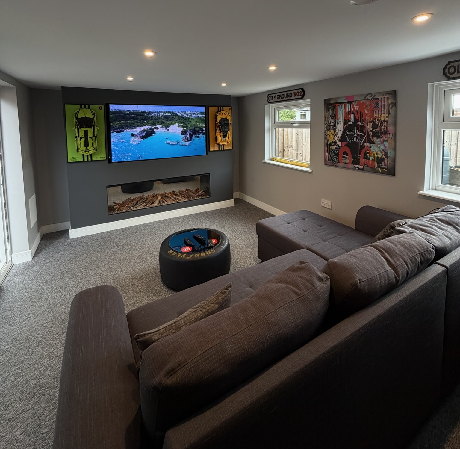 Detached garage conversion in Timperley transformed into a luxury man cave with media wall, feature fireplace, retained garage door, side sliding doors and integrated storage space. Detached garage conversion in Timperley transformed into a luxury man cave with media wall, feature fireplace, retained garage door, side sliding doors and integrated storage space.