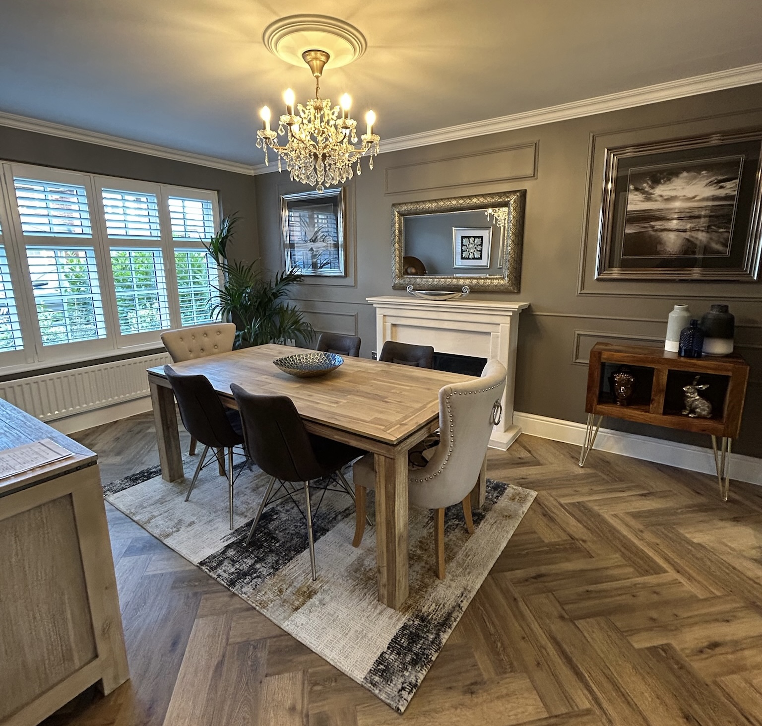 Luxury kitchen extension in Great Sankey with herringbone flooring, feature chandelier, wall panelling and modern dining area