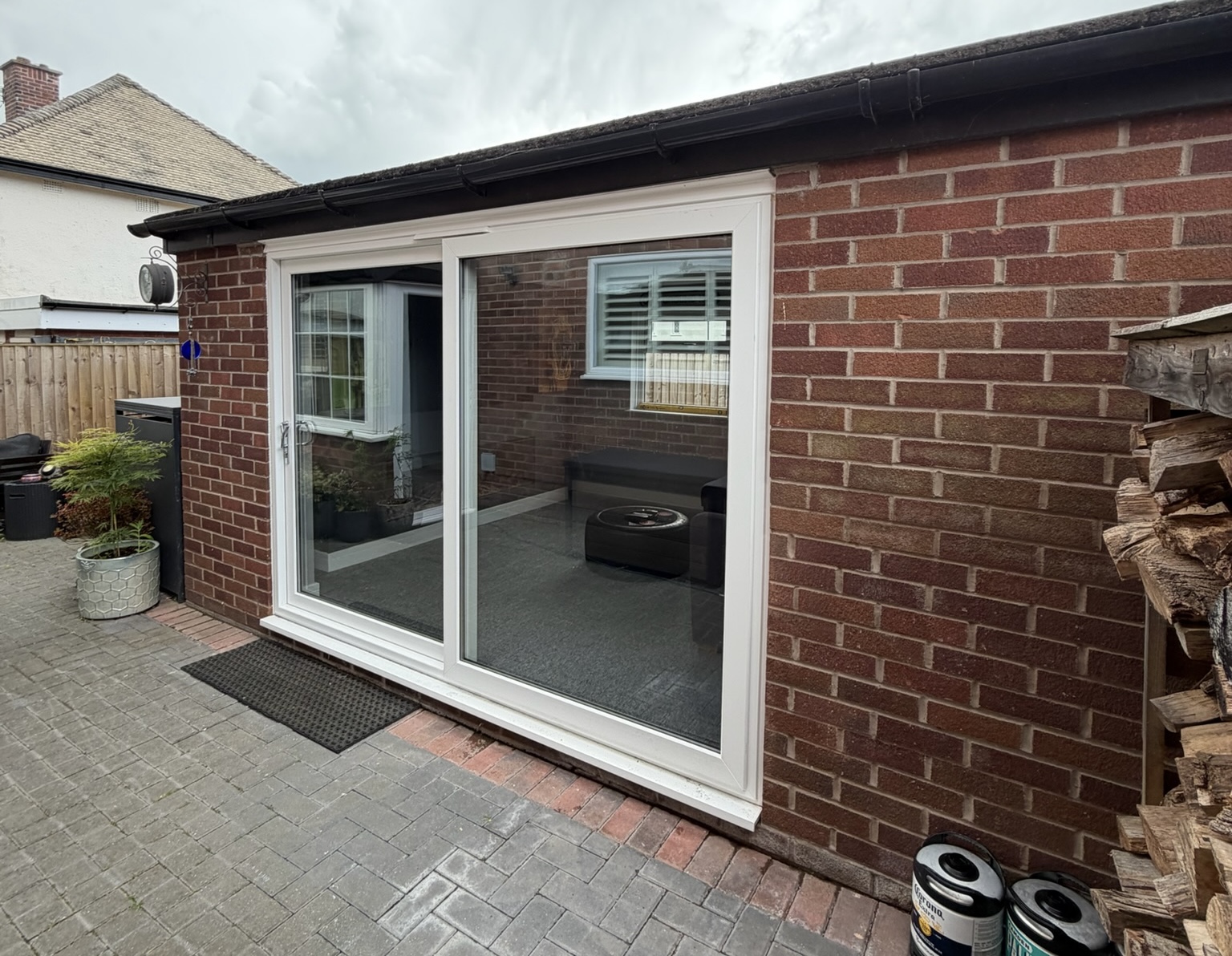 Garage conversion in Timperley with large sliding patio doors while keeping the front section of the garage for practical storage space Garage conversion in Timperley with large sliding patio doors while keeping the front section of the garage for practical storage space