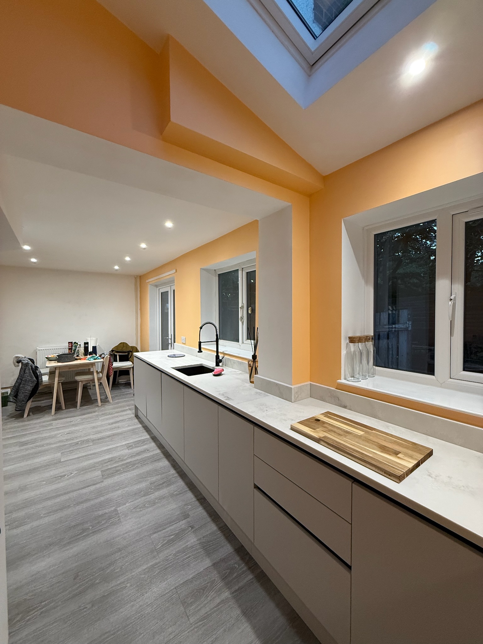 Kitchen extension completed in Moston featuring modern fitted units, skylight roof window, long worktop space and practical built in kitchen storage Kitchen extension completed in Moston featuring modern fitted units, skylight roof window, long worktop space and practical built in kitchen storage
