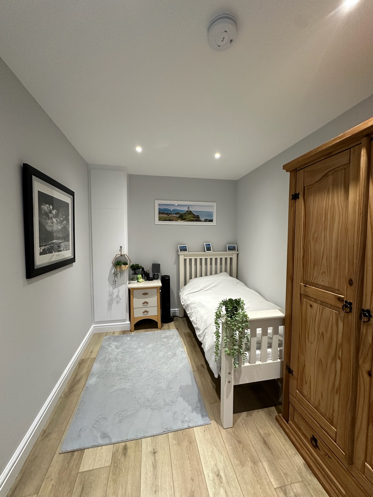Single garage conversion transformed into a bedroom in Chester with integrated storage and modern finishes.