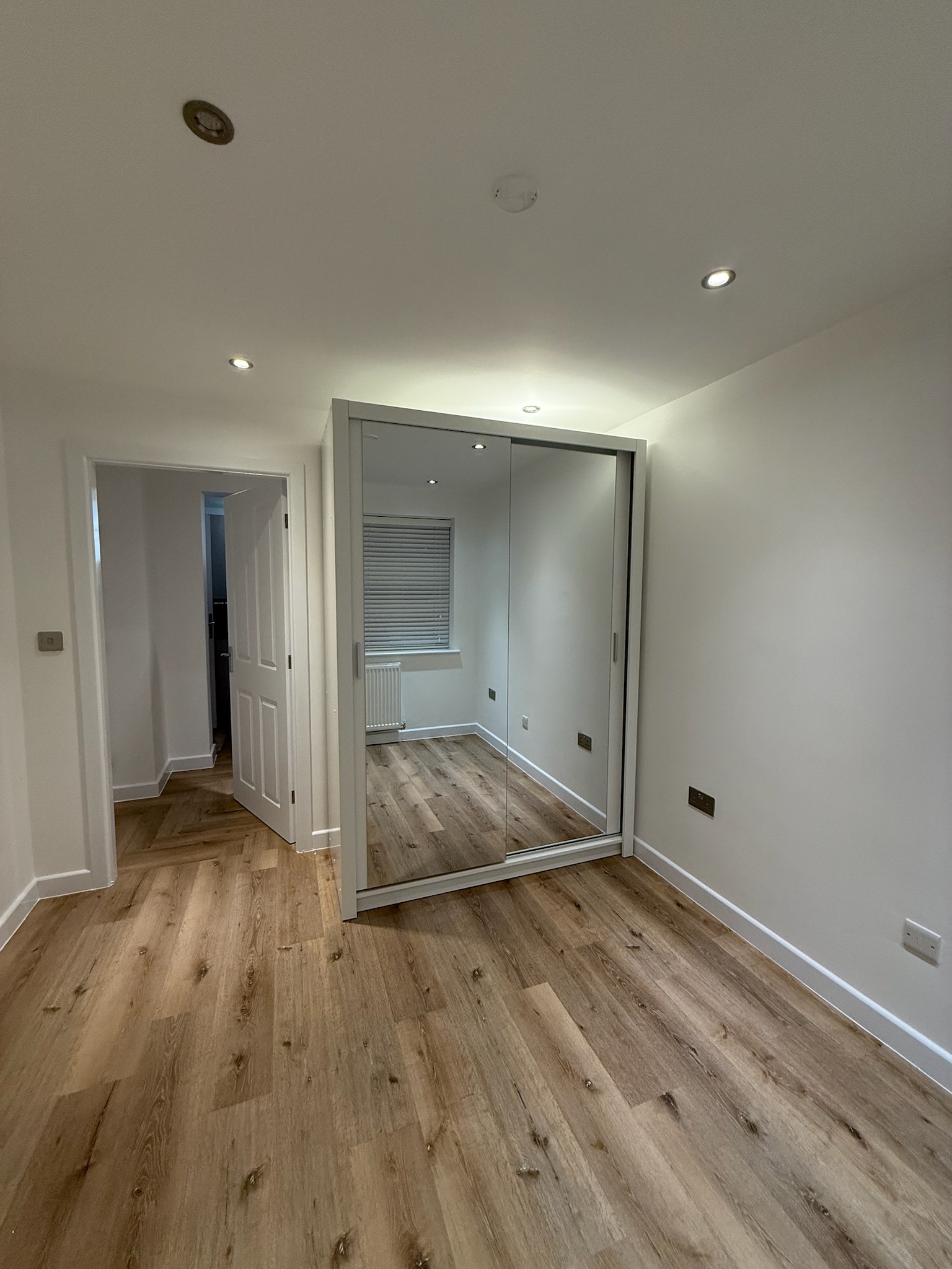 Double garage conversion in Leigh transformed into a spacious bedroom with fitted wardrobes, wood effect flooring and modern finishes. Double garage conversion in Leigh transformed into a spacious bedroom with fitted wardrobes, wood effect flooring and modern finishes.