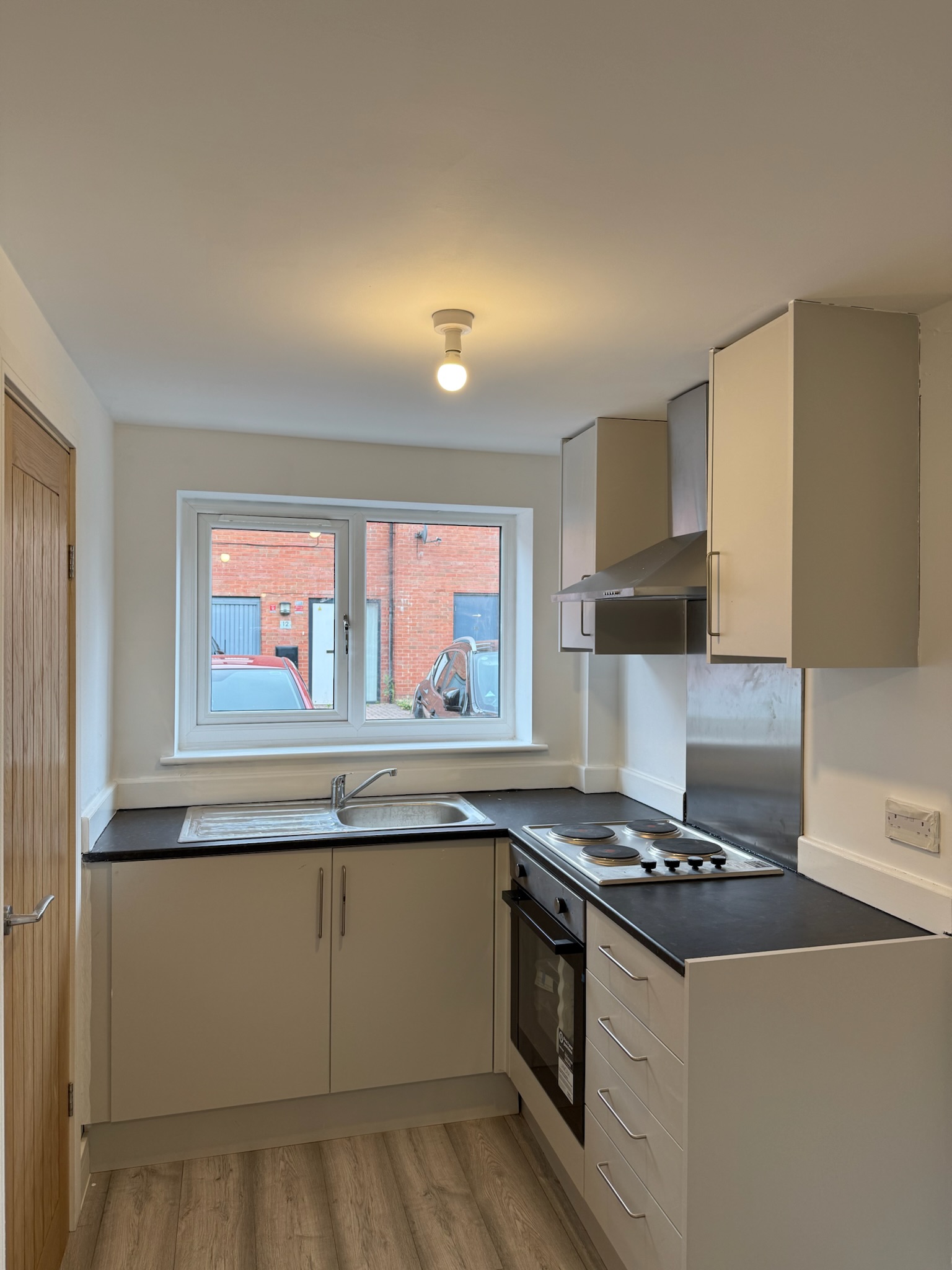 Kitchenette installed as part of a garage annexe conversion in Droylsden featuring bedroom, en suite and independent living space Kitchenette installed as part of a garage annexe conversion in Droylsden featuring bedroom, en suite and independent living space