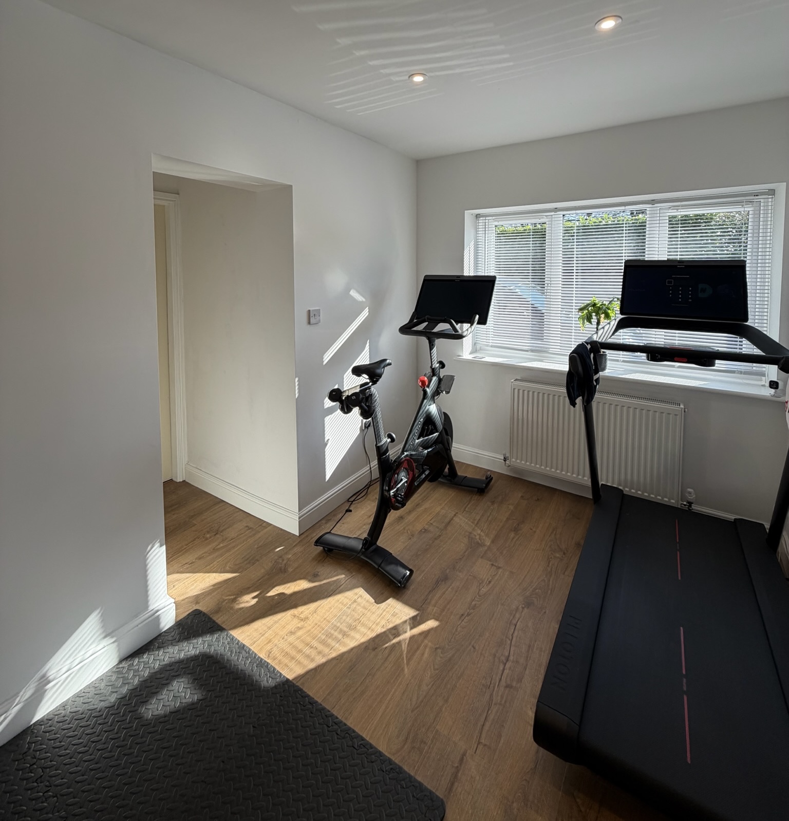 Single garage conversion in Urmston transformed into a bright home gym with treadmill, exercise bike, workout area, large front window and insulated living space. Single garage conversion in Urmston transformed into a bright home gym with treadmill, exercise bike, workout area, large front window and insulated living space.