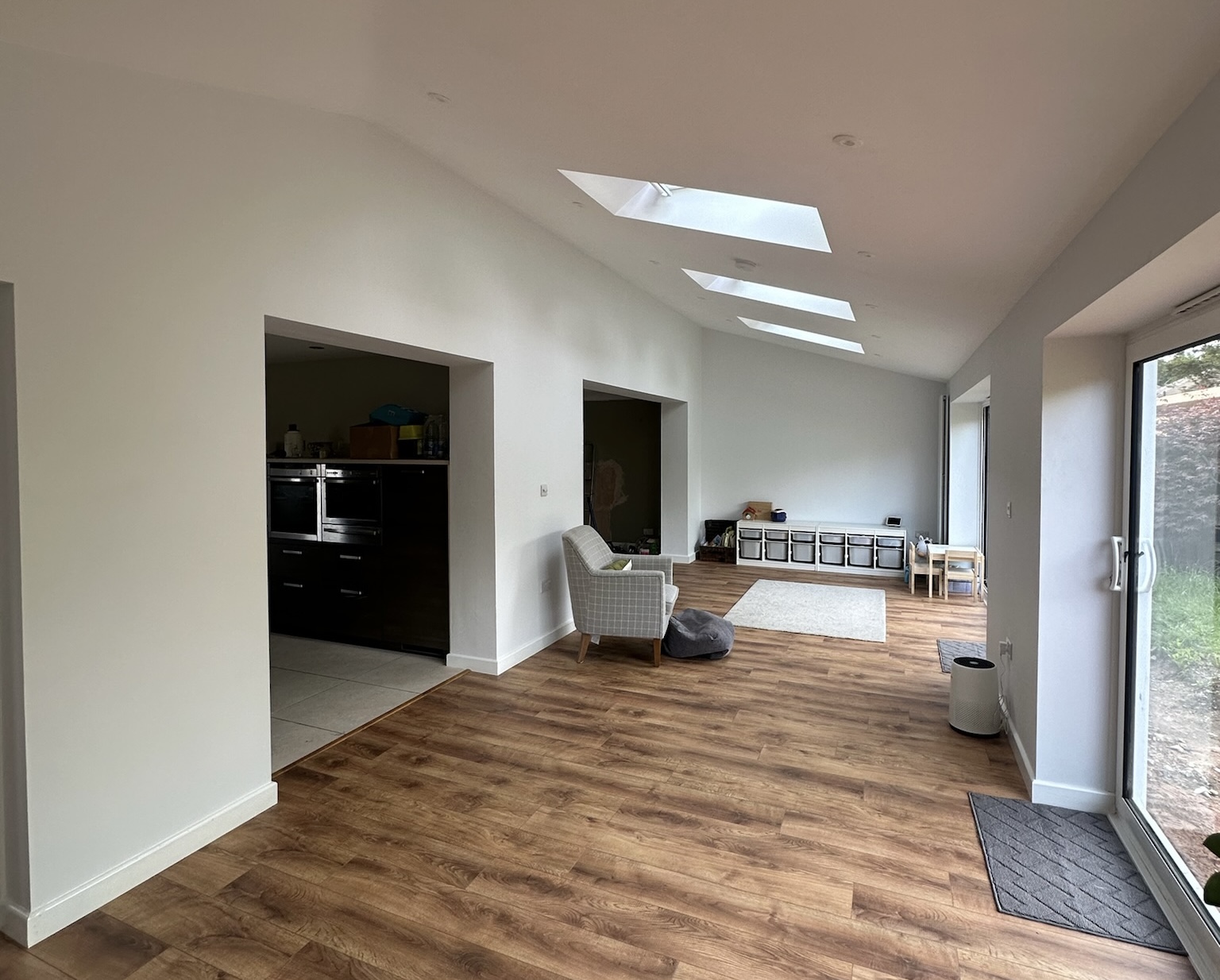 Rear house extension in Radcliffe featuring multiple skylights, large bifold doors, open plan living space and natural light filled family room.