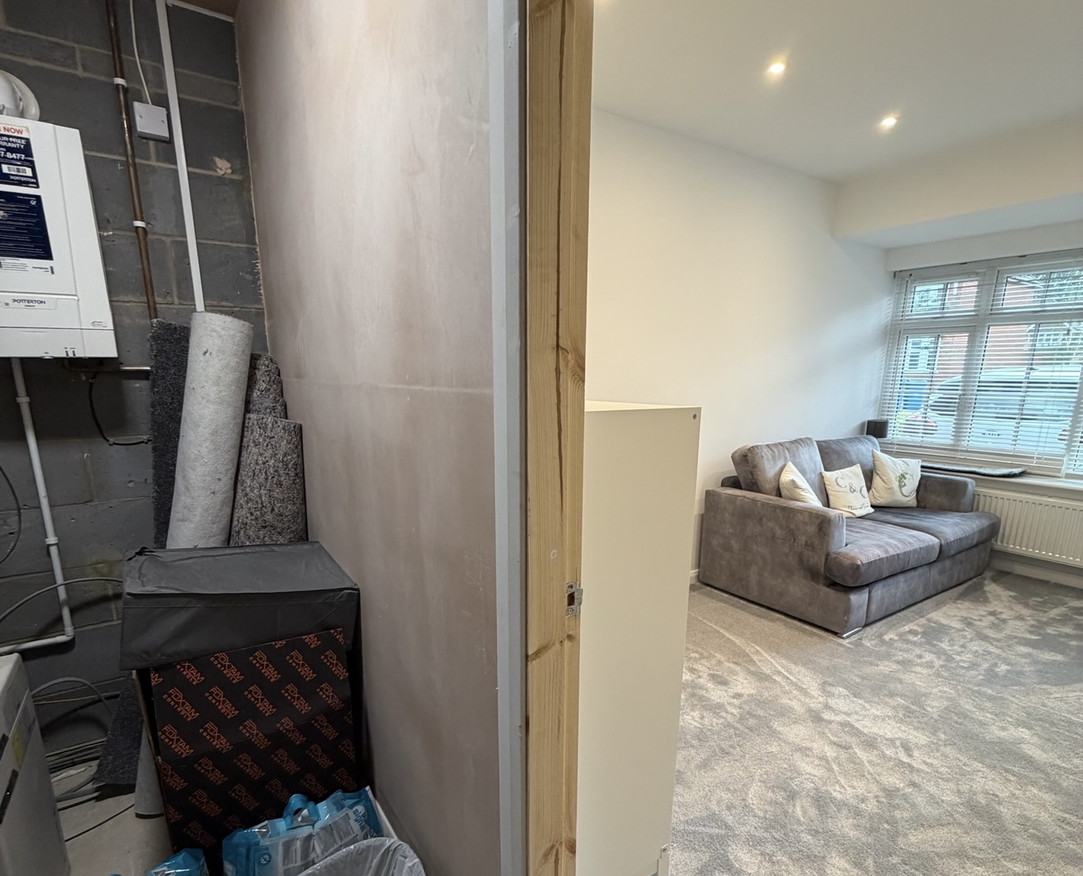 Garage conversion with retained storage area and comfortable living space in Greater Manchester.