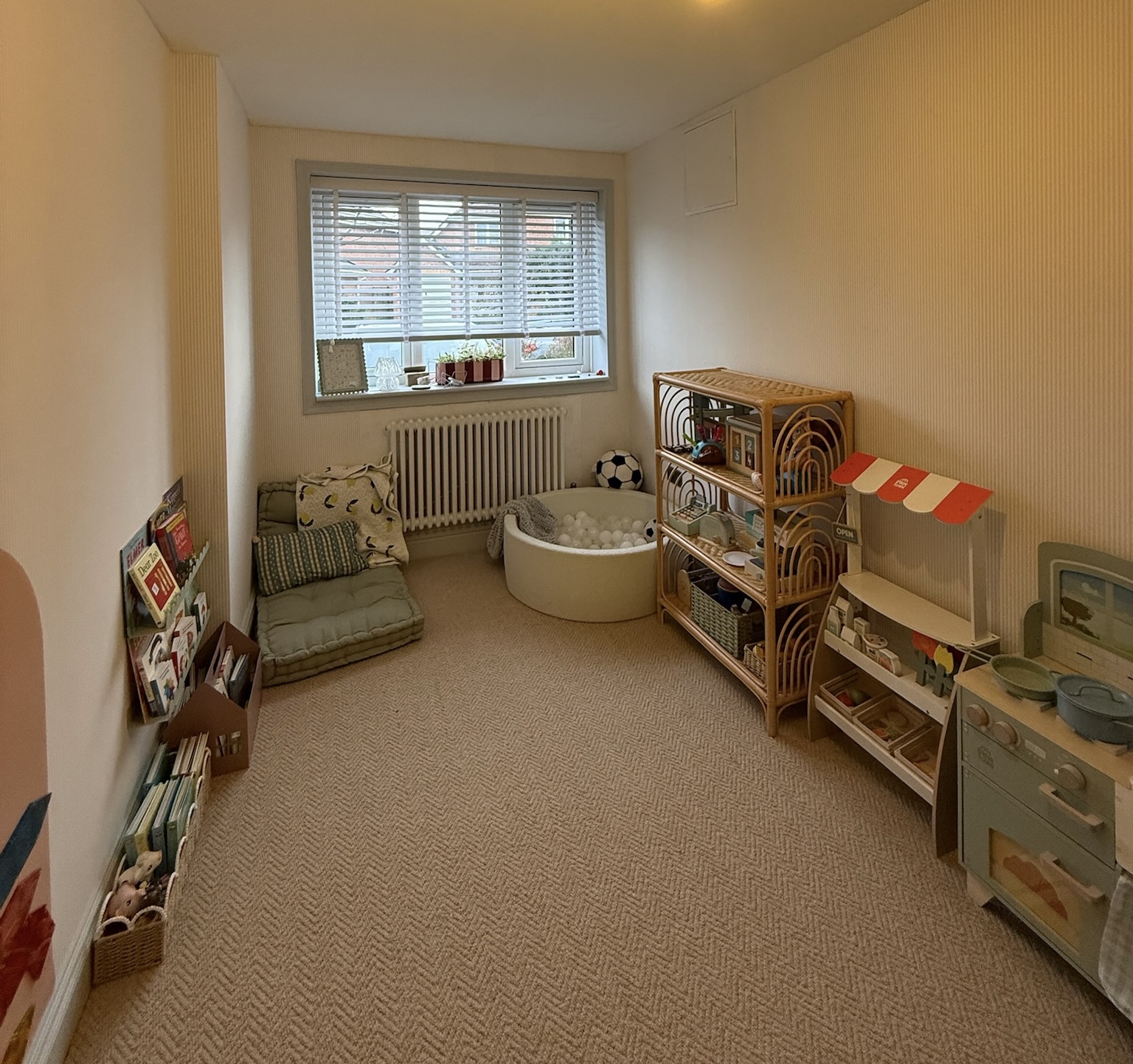 Single garage conversion in Northwich transformed into a bright and practical playroom with dedicated storage, reading corner and space for children to play.