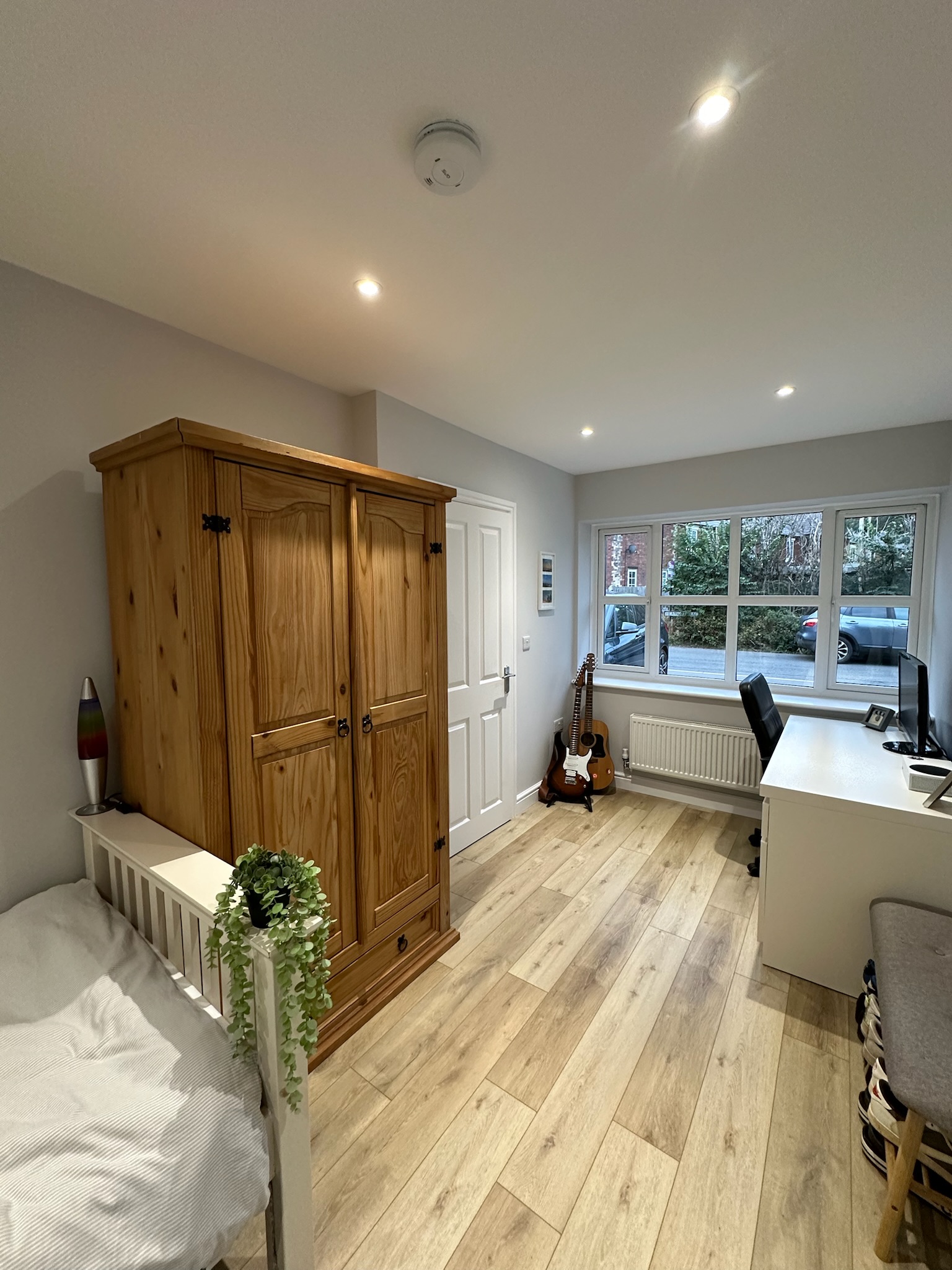 Modern bedroom with home office created from a single brick garage conversion in Sandbach.