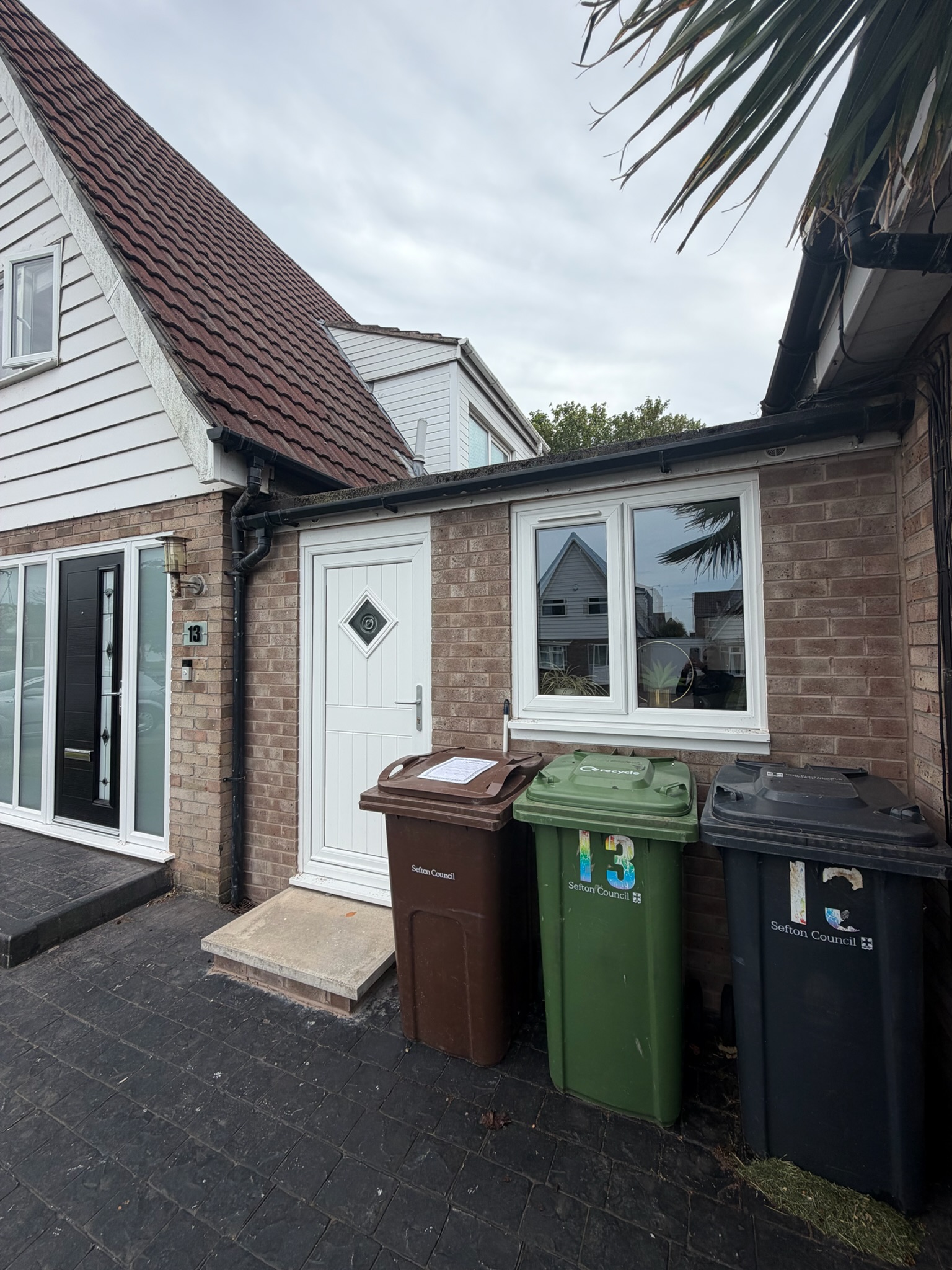 Exterior of a single attached garage converted into a granny annexe, with a new entrance door and window. Exterior of a single attached garage converted into a granny annexe, with a new entrance door and window.