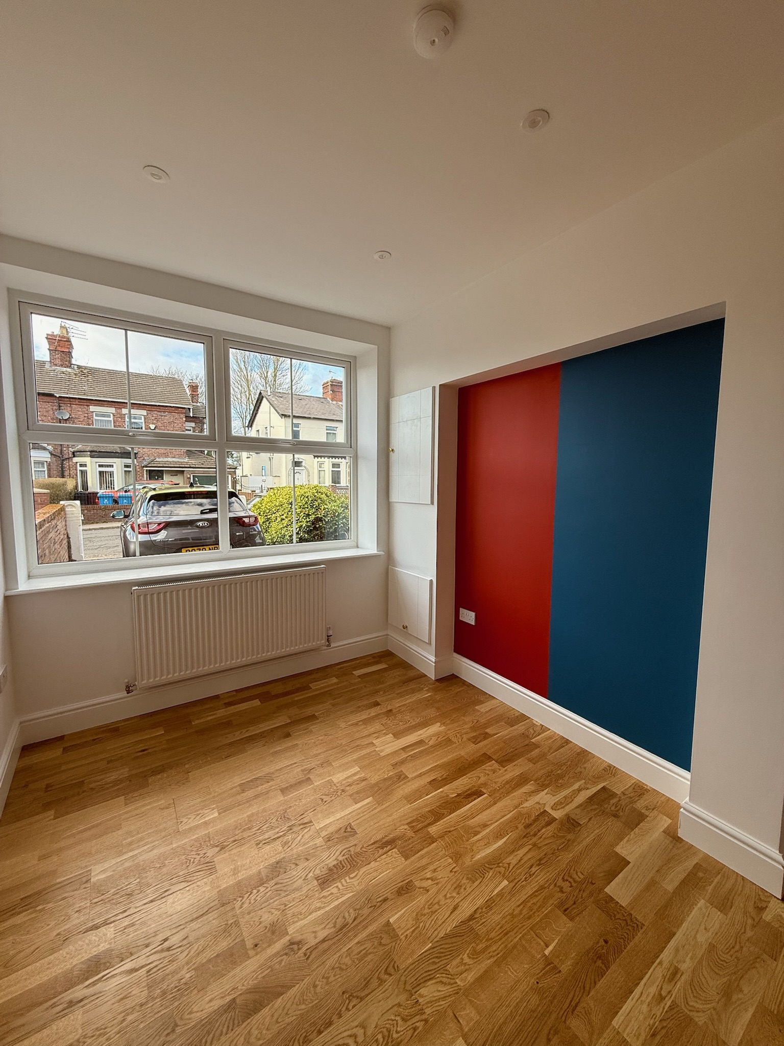 Single garage conversion in Liverpool finished as an additional room with natural wood flooring and a large front window. Single garage conversion in Liverpool finished as an additional room with natural wood flooring and a large front window.