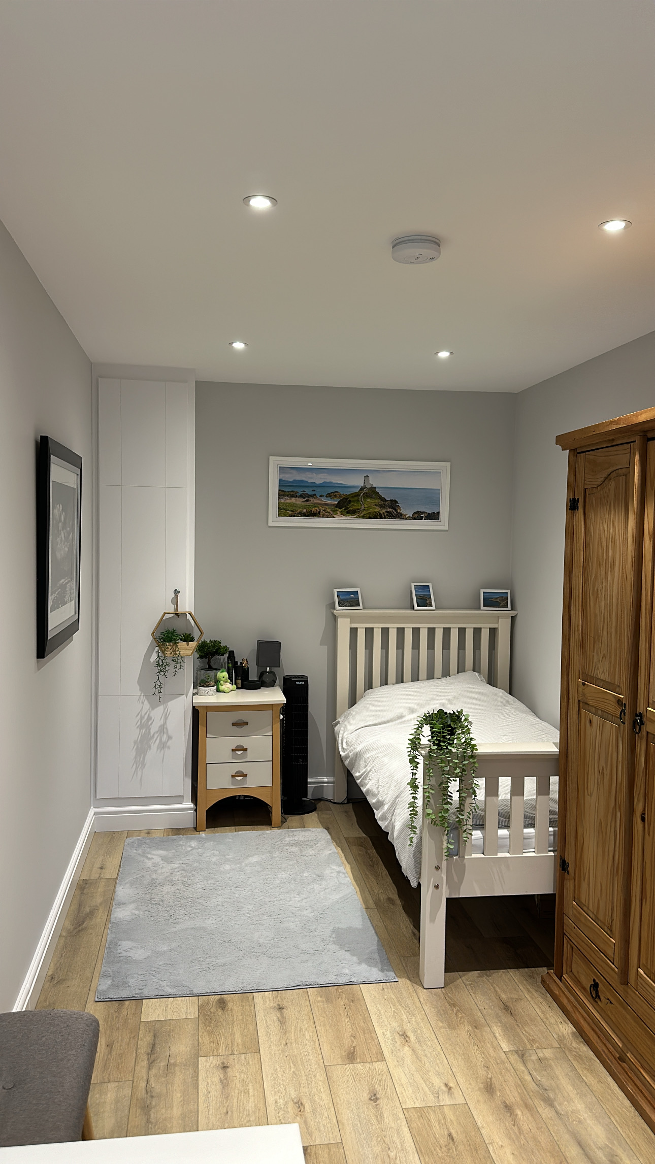 Narrow single garage conversion in Wigan transformed into a bedroom with carefully positioned furniture and fitted storage. Narrow single garage conversion in Wigan transformed into a bedroom with carefully positioned furniture and fitted storage.