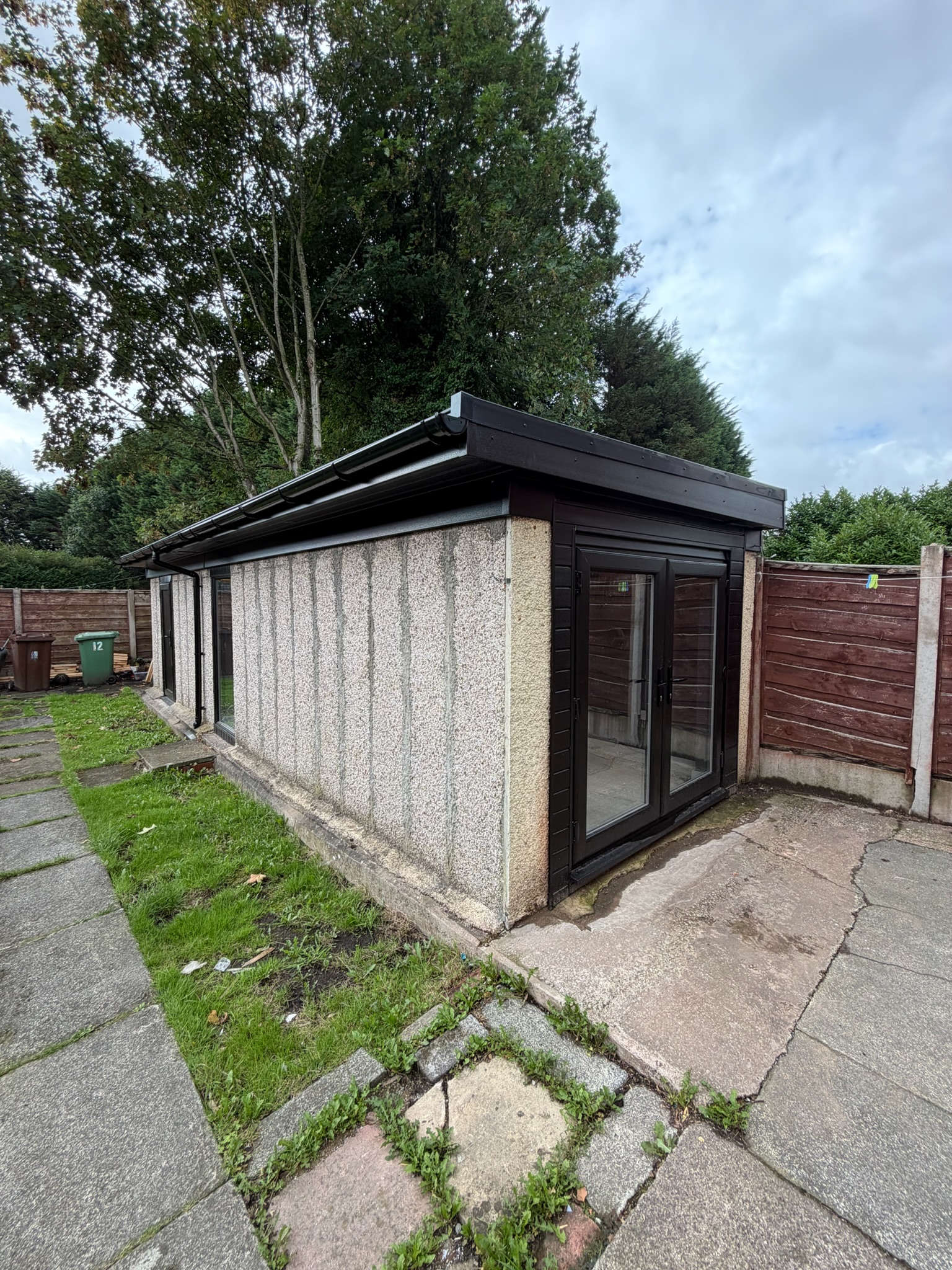 Sectional concrete prefab garage conversion in Wigan converted into a home gym with French doors