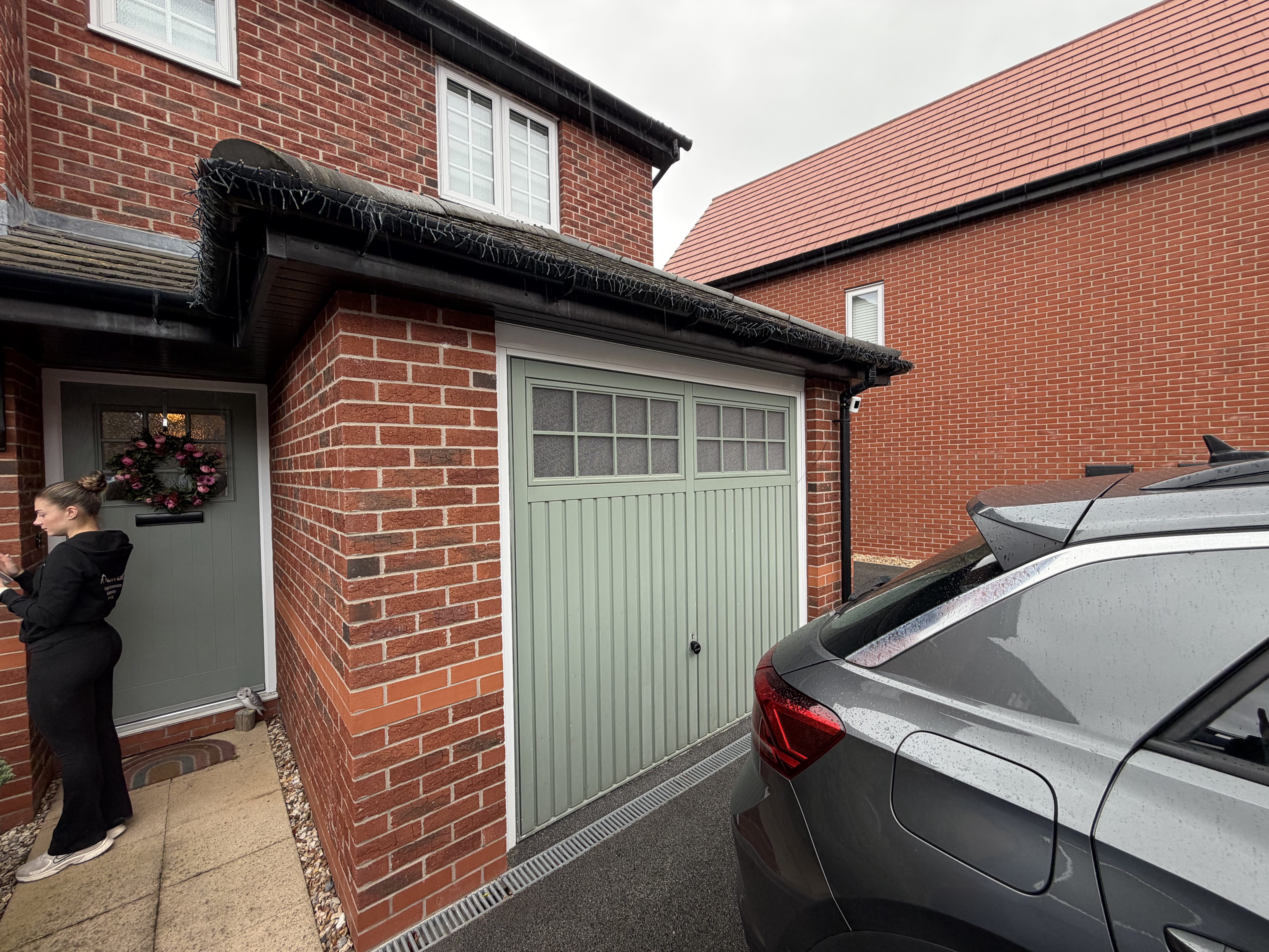 Exterior of a single garage conversion in Warrington with the original garage door retained and storage kept at the front of the property. Exterior of a single garage conversion in Warrington with the original garage door retained and storage kept at the front of the property.