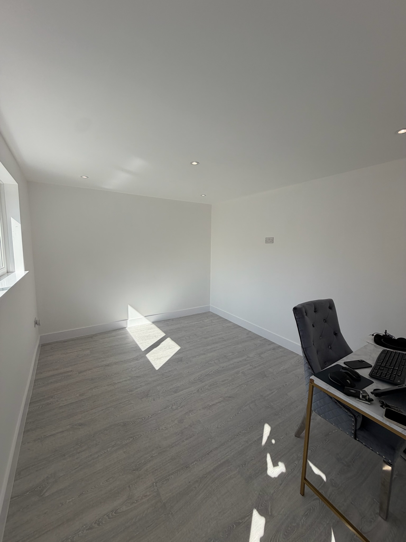 Single garage conversion in Wigan transformed into a bright home office with grey flooring and retained garage storage at the front. Single garage conversion in Wigan transformed into a bright home office with grey flooring and retained garage storage at the front.