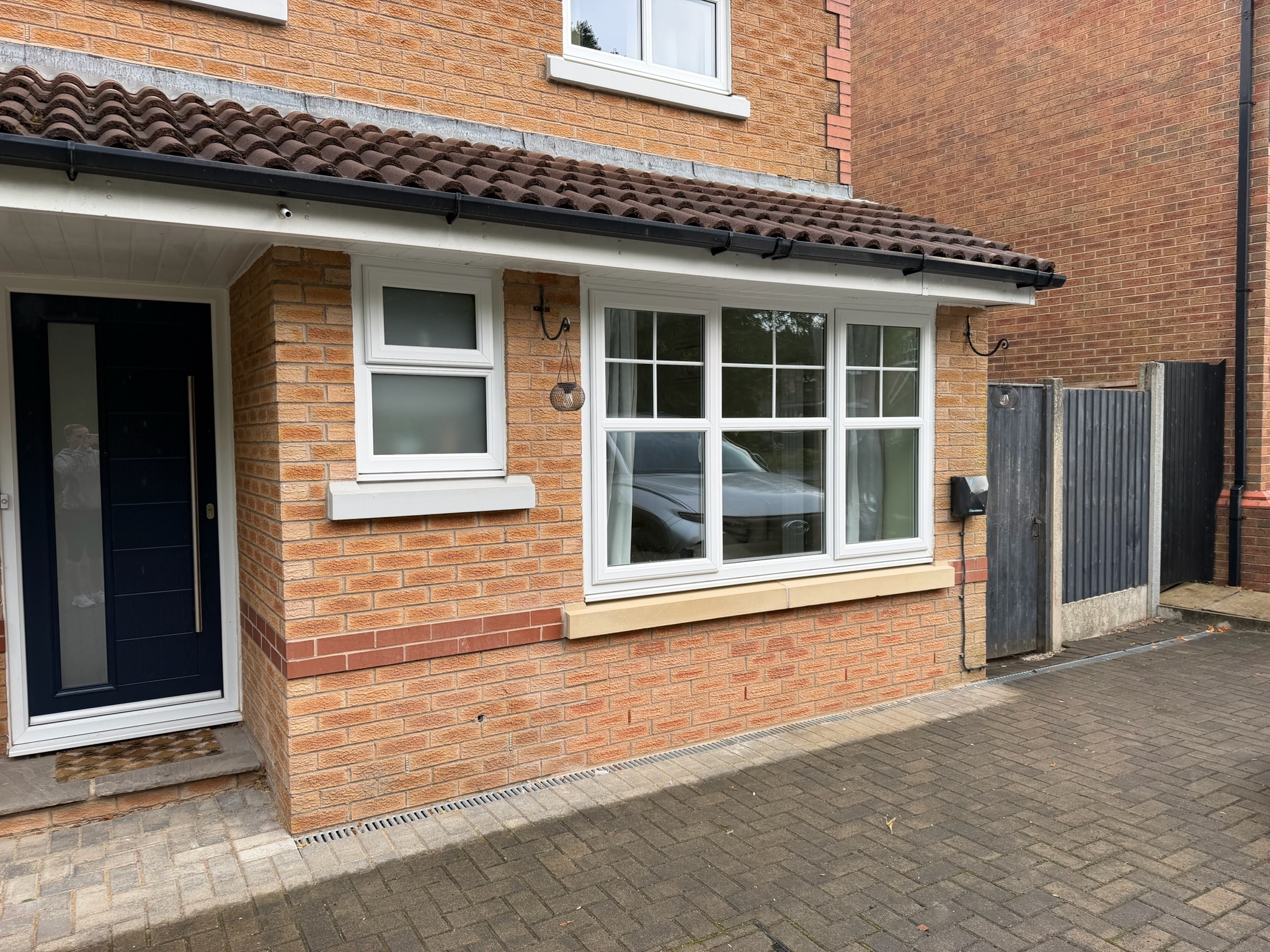 Exterior of a completed garage conversion in Lower Darwen with matching brickwork, new windows and access door integrated into the property. Exterior of a completed garage conversion in Lower Darwen with matching brickwork, new windows and access door integrated into the property.
