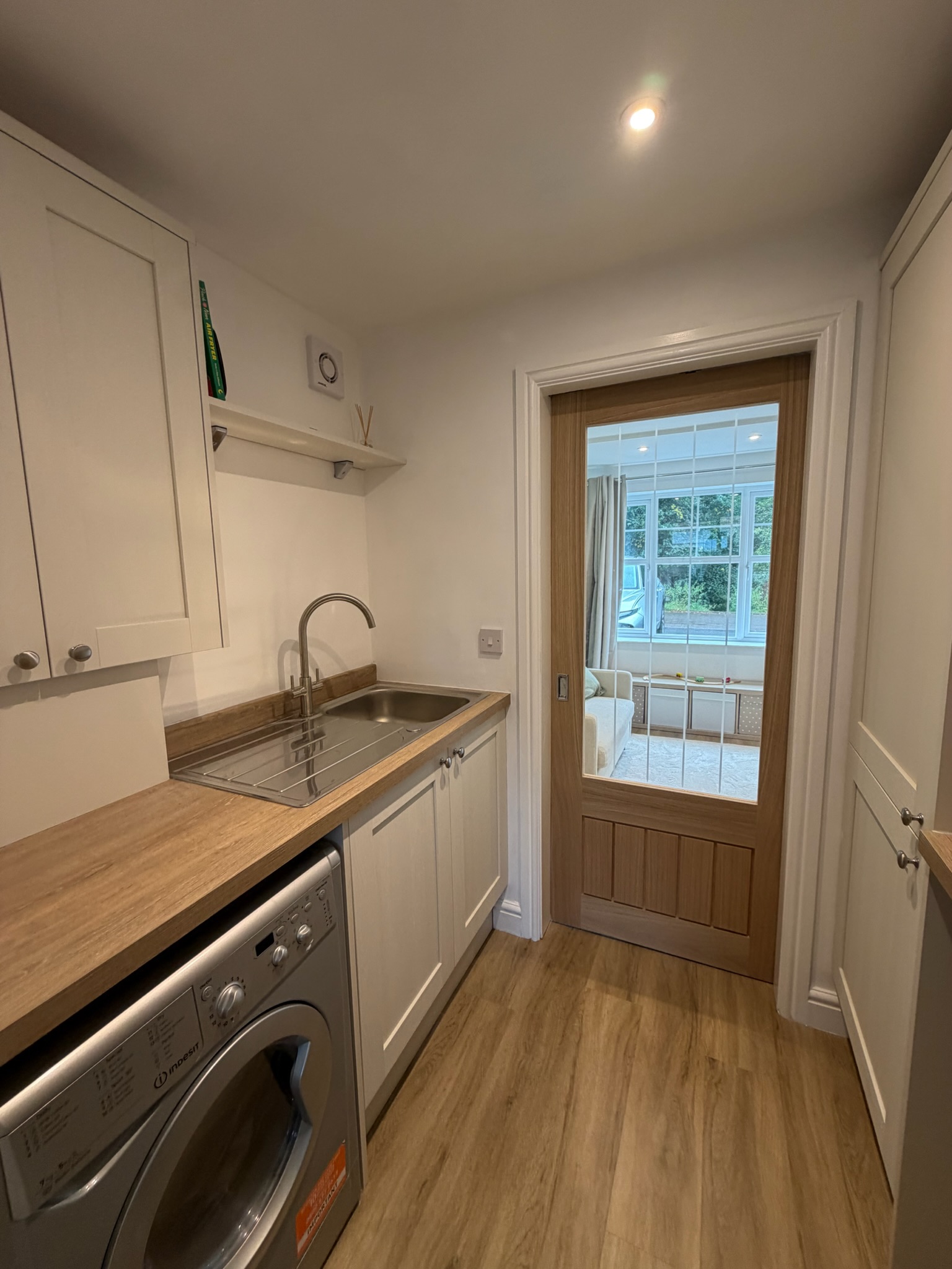 Garage conversion in Lower Darwen creating a new living space and separate utility room, divided by a glazed sliding internal door. Garage conversion in Lower Darwen creating a new living space and separate utility room, divided by a glazed sliding internal door.