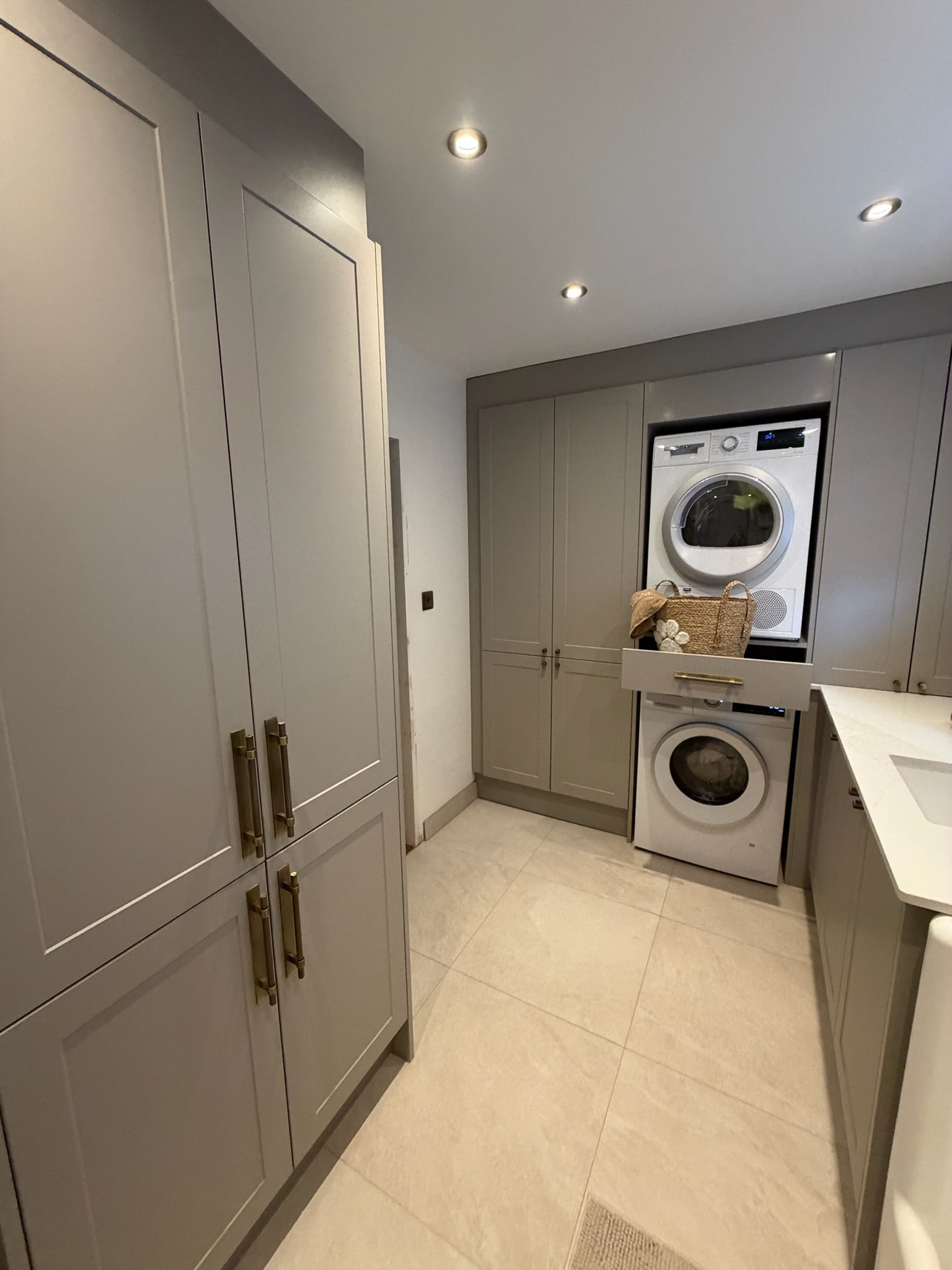 Garage conversion in Chorley transformed into a utility and dog wash room with fitted cupboards providing practical additional household storage. Garage conversion in Chorley transformed into a utility and dog wash room with fitted cupboards providing practical additional household storage.