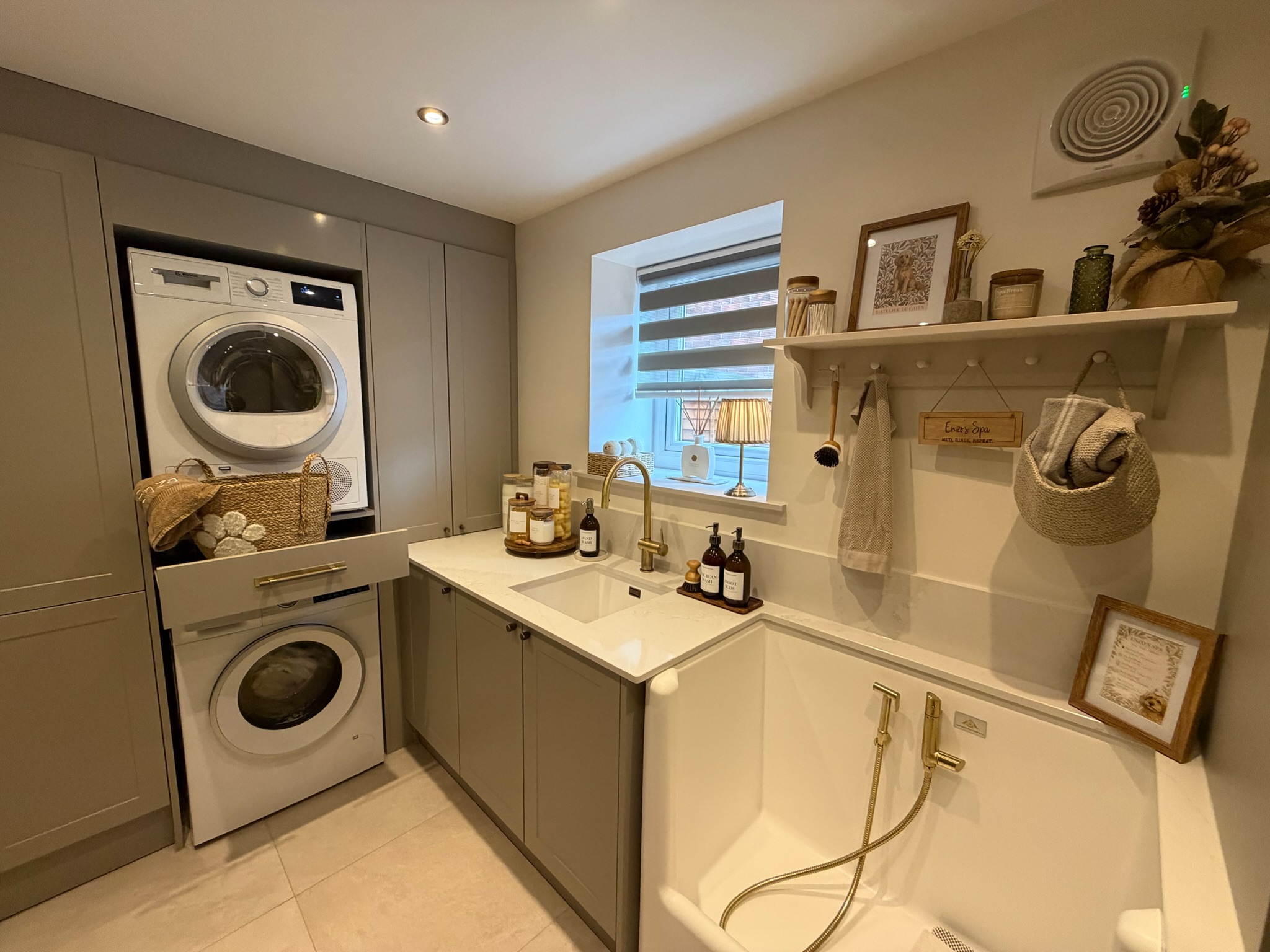 Garage conversion in Chorley combining a dog washing station with stacked laundry appliances, fitted cupboards, worktops and practical storage. Garage conversion in Chorley combining a dog washing station with stacked laundry appliances, fitted cupboards, worktops and practical storage.