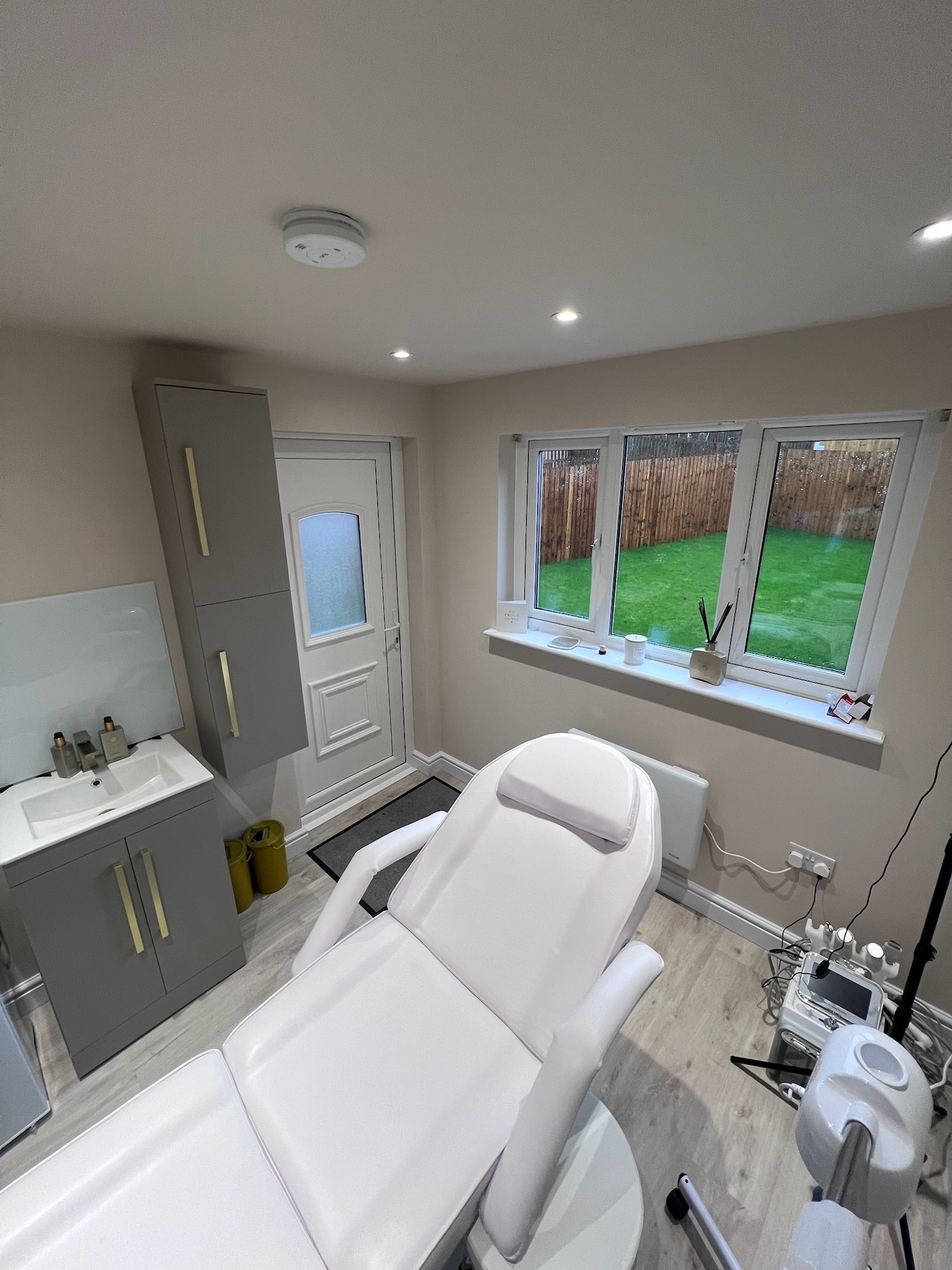 Beauty salon created from a single garage conversion in Rochdale, featuring a treatment chair, washbasin, fitted storage and natural light. Beauty salon created from a single garage conversion in Rochdale, featuring a treatment chair, washbasin, fitted storage and natural light.
