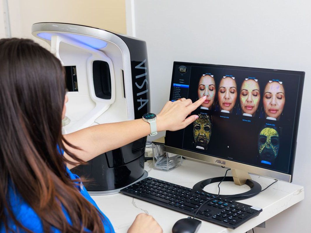 A SkinLab team member reviewing a client's skin analysis on screen