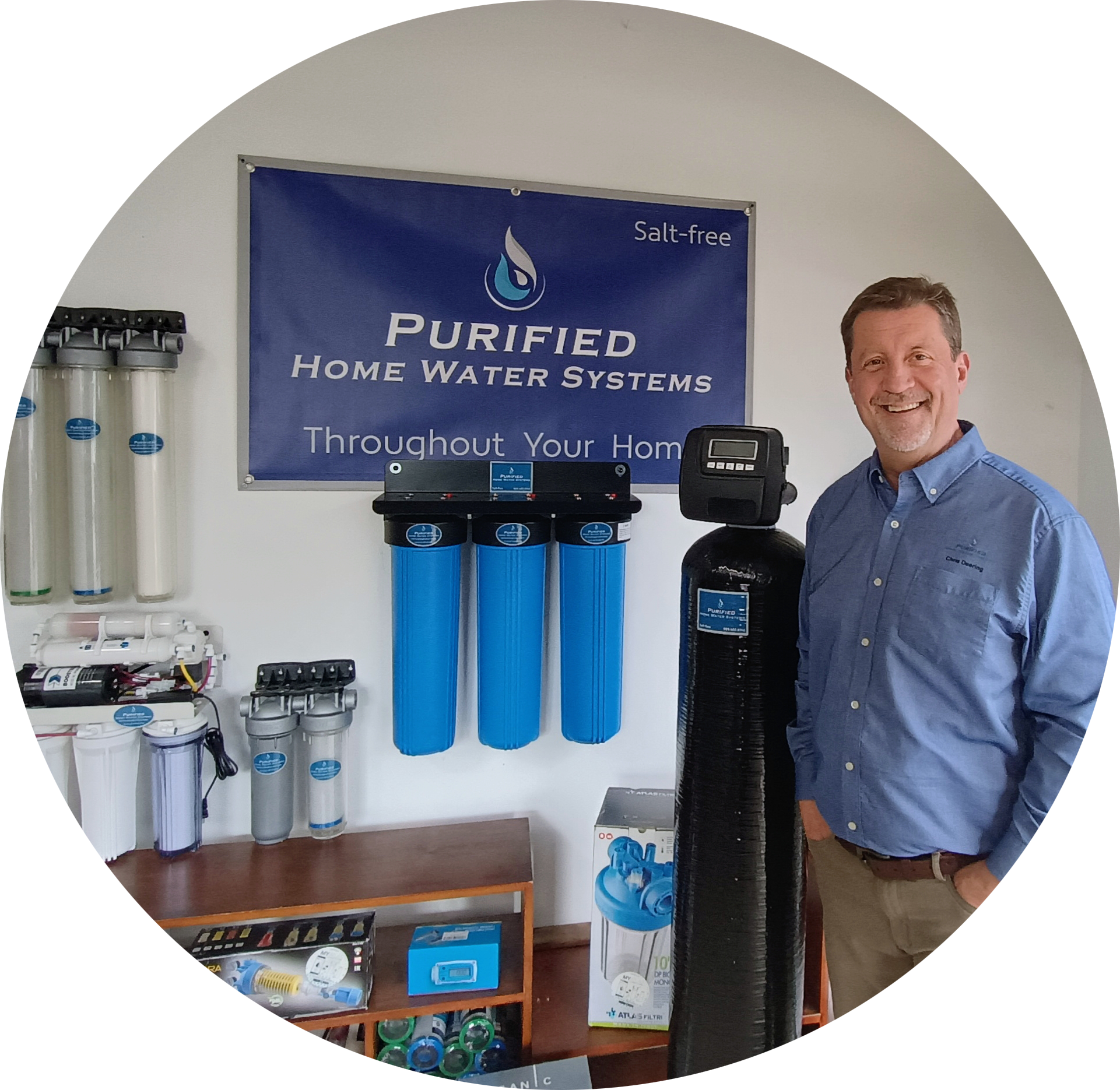 Owner, Chris, standing next to a purificaion sysem