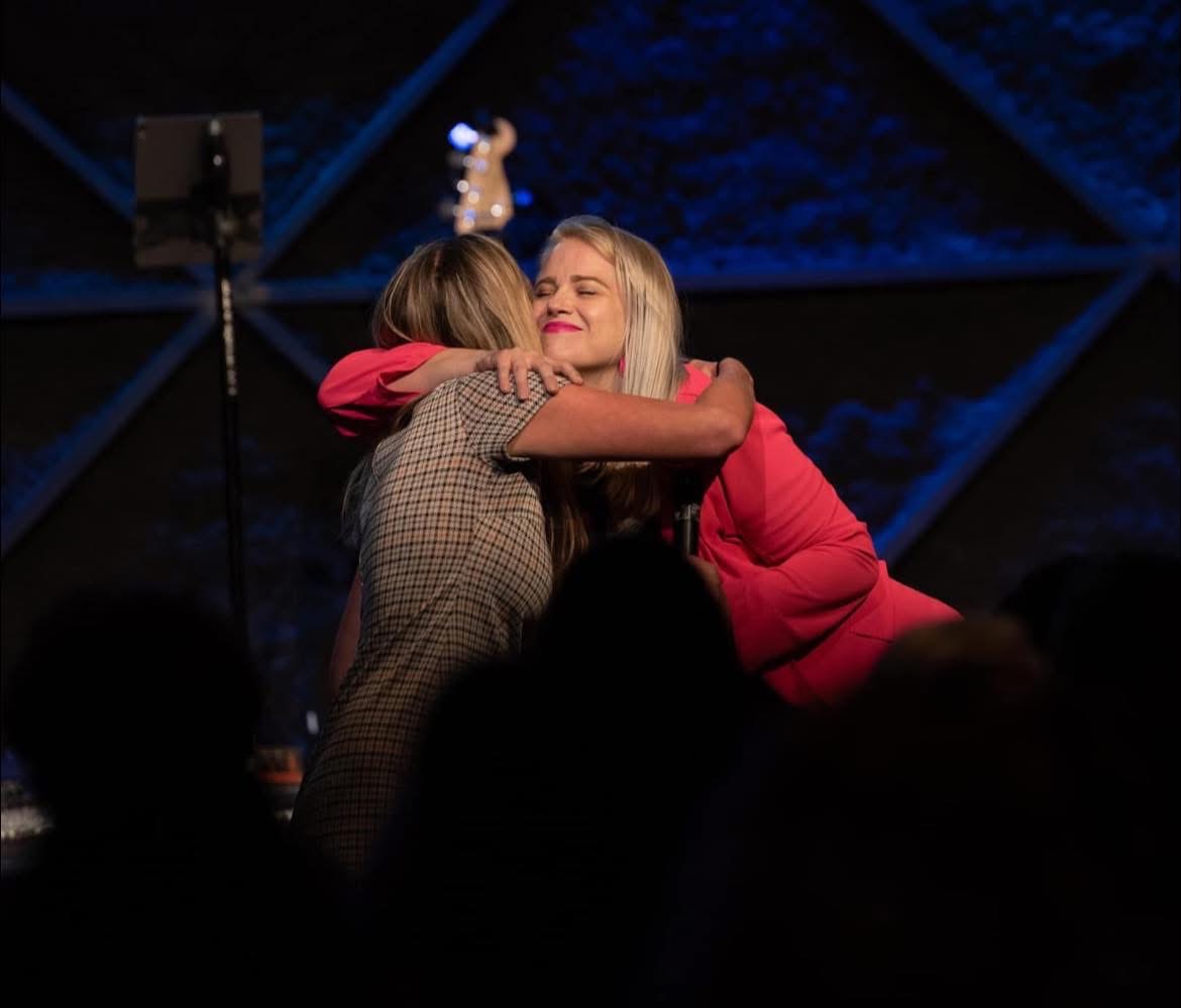 Samantha Virella embracing a She's Kingdom member