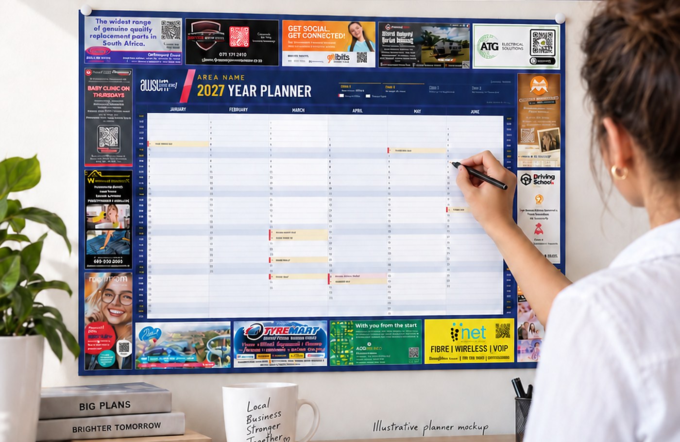The 2027 AWSUM Wall Planner on a wall, with advertising positions around the year grid