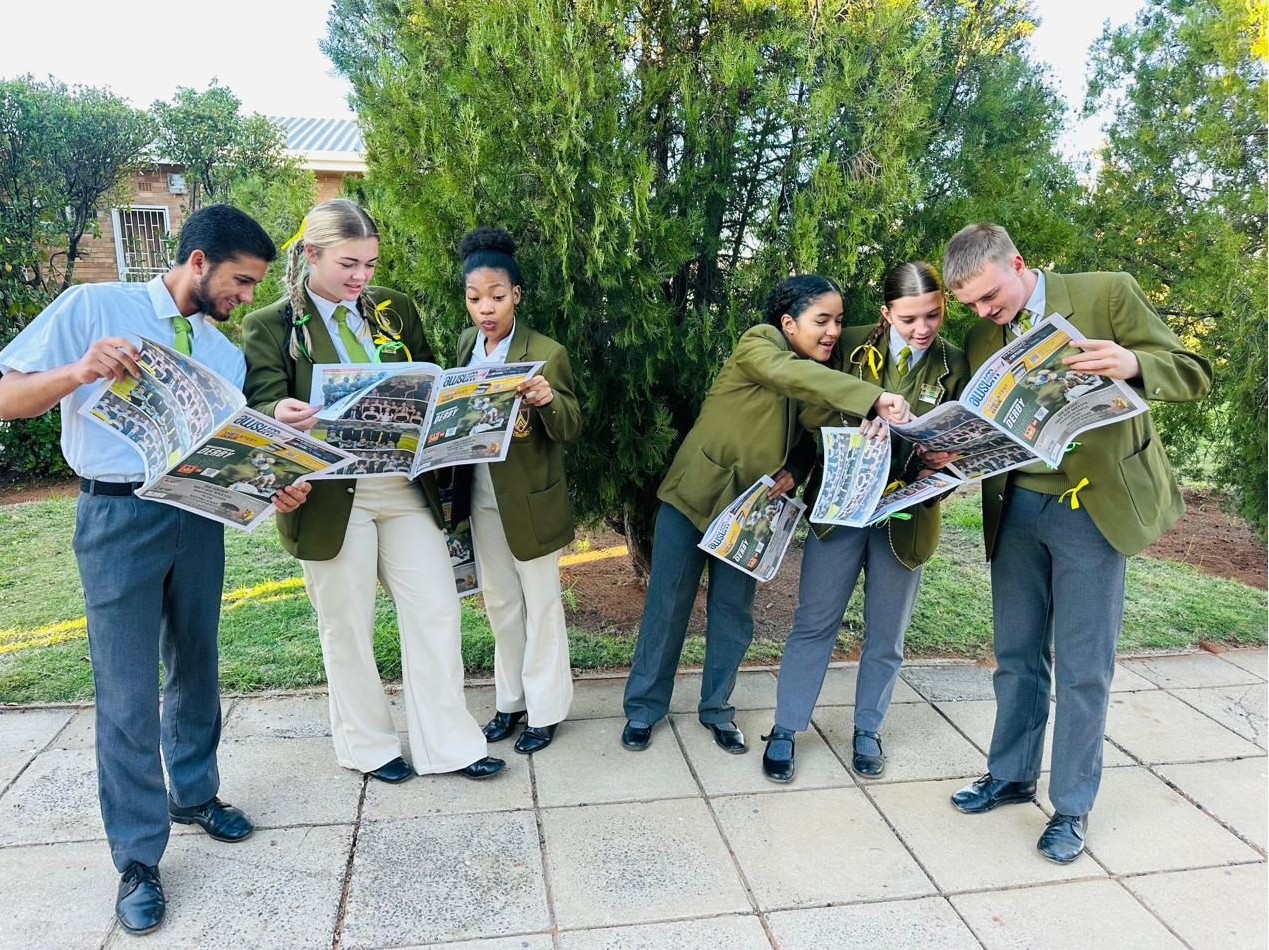 Learners at a participating school reading an AWSUM edition together
