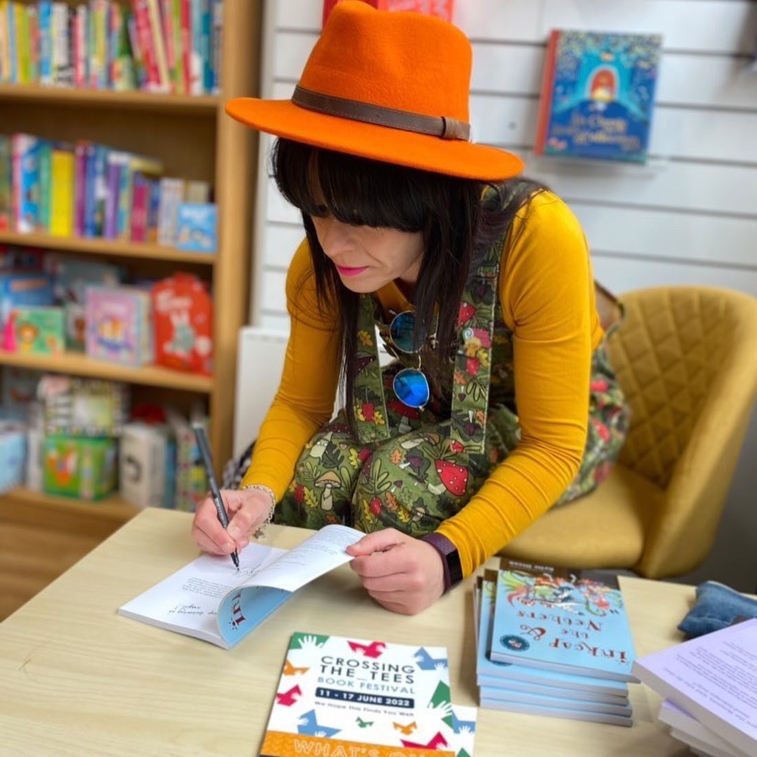 Kylie Dixon signing a book