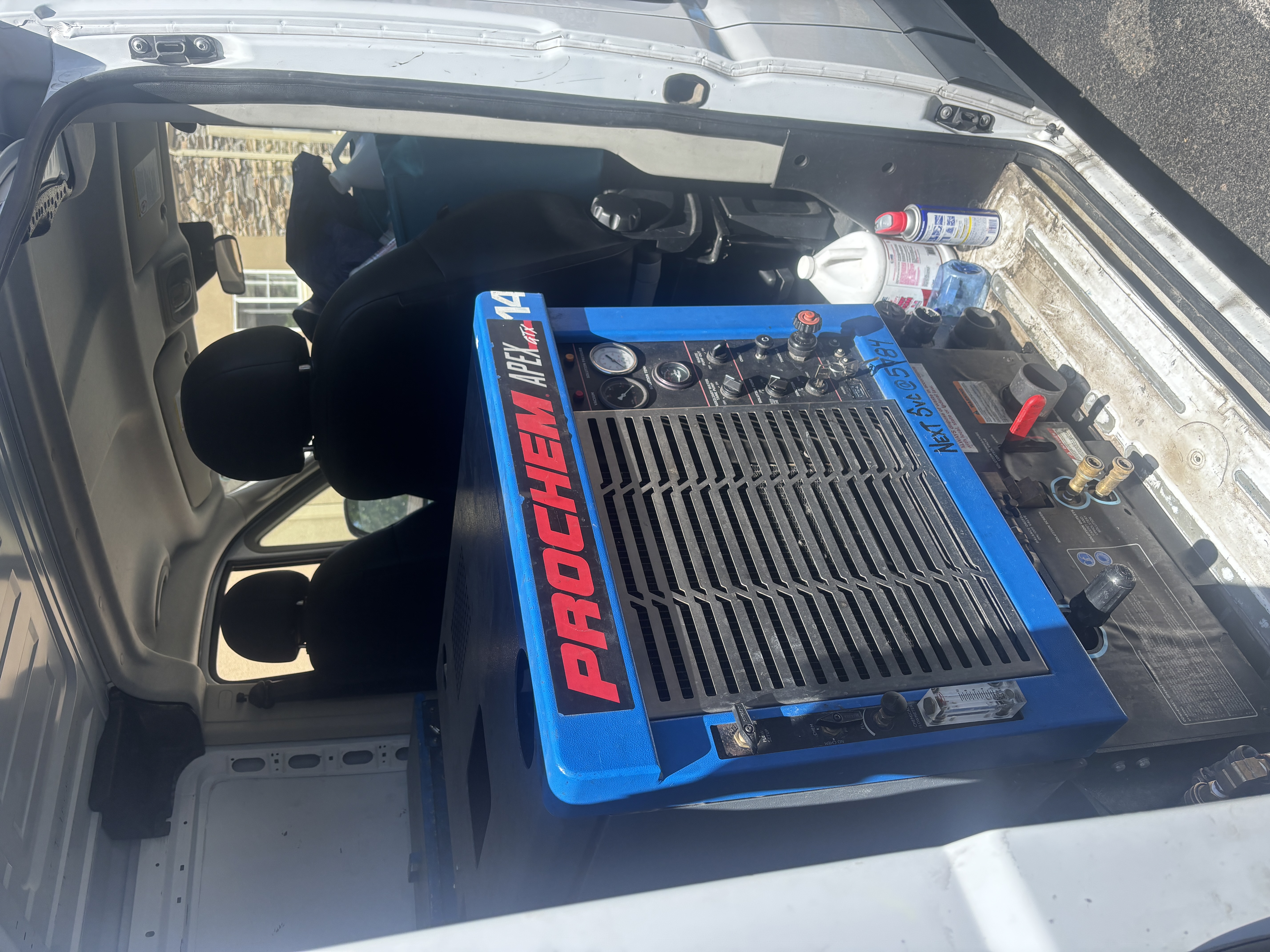 Prochem and Sapphire Scientific truckmount carpet cleaning equipment in a service van