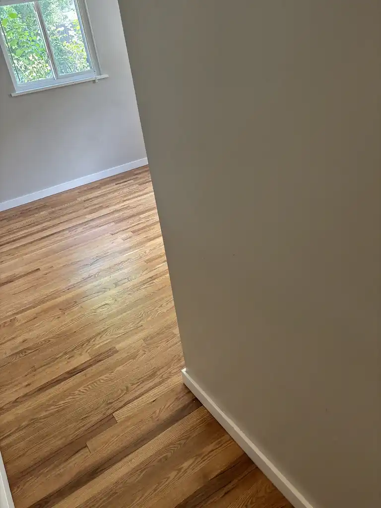 Castle Pines LVT abrasive soil — red clay iron oxide and pine forest grit removed by pre-vacuuming before wet cleaning