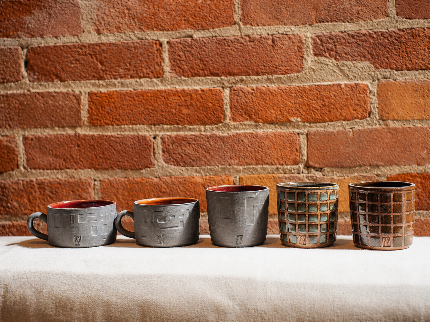 Row of handmade ceramic cups