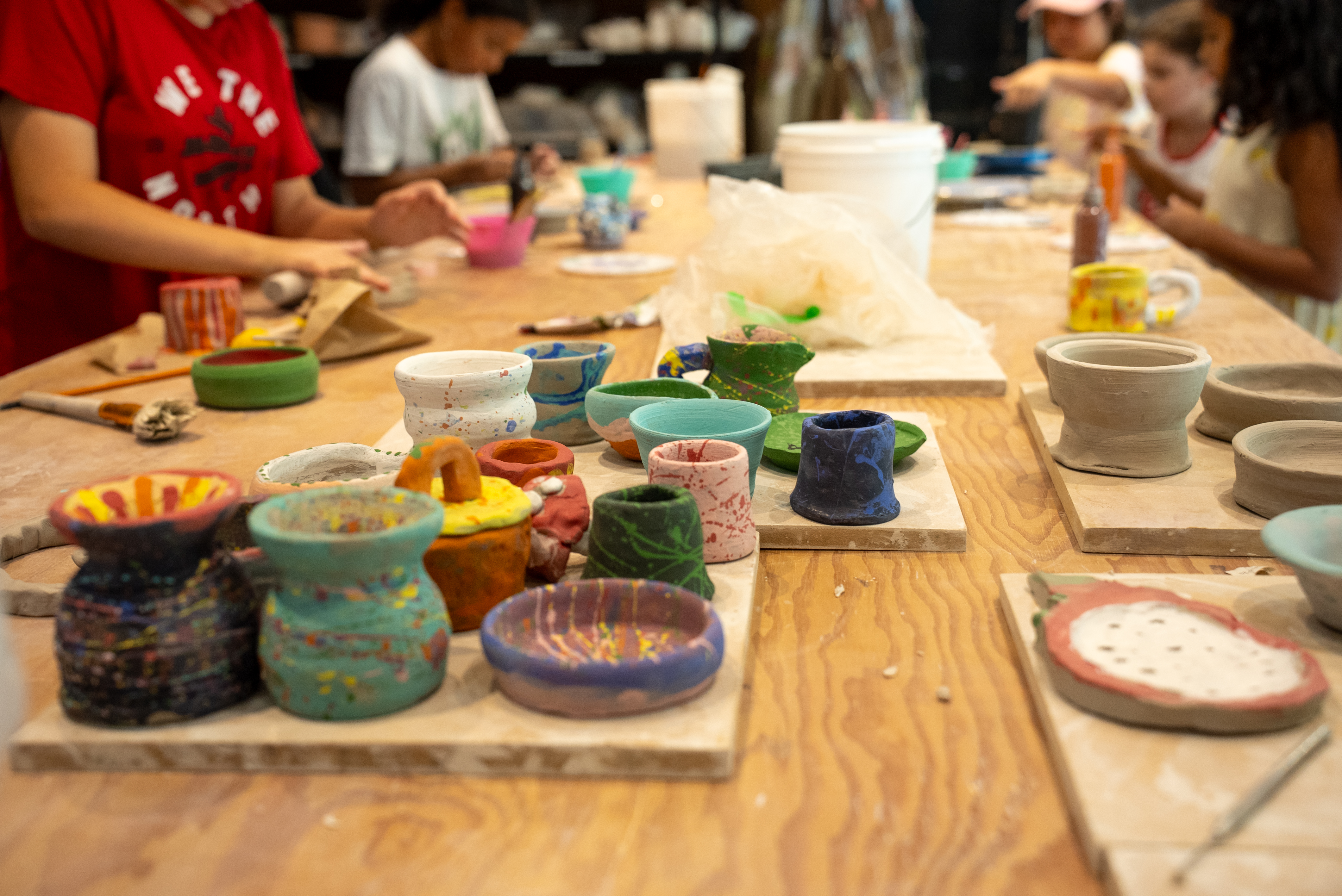 Creating and painting handmade pottery during a Build and Paint Workshop at Spin Pottery Studio.