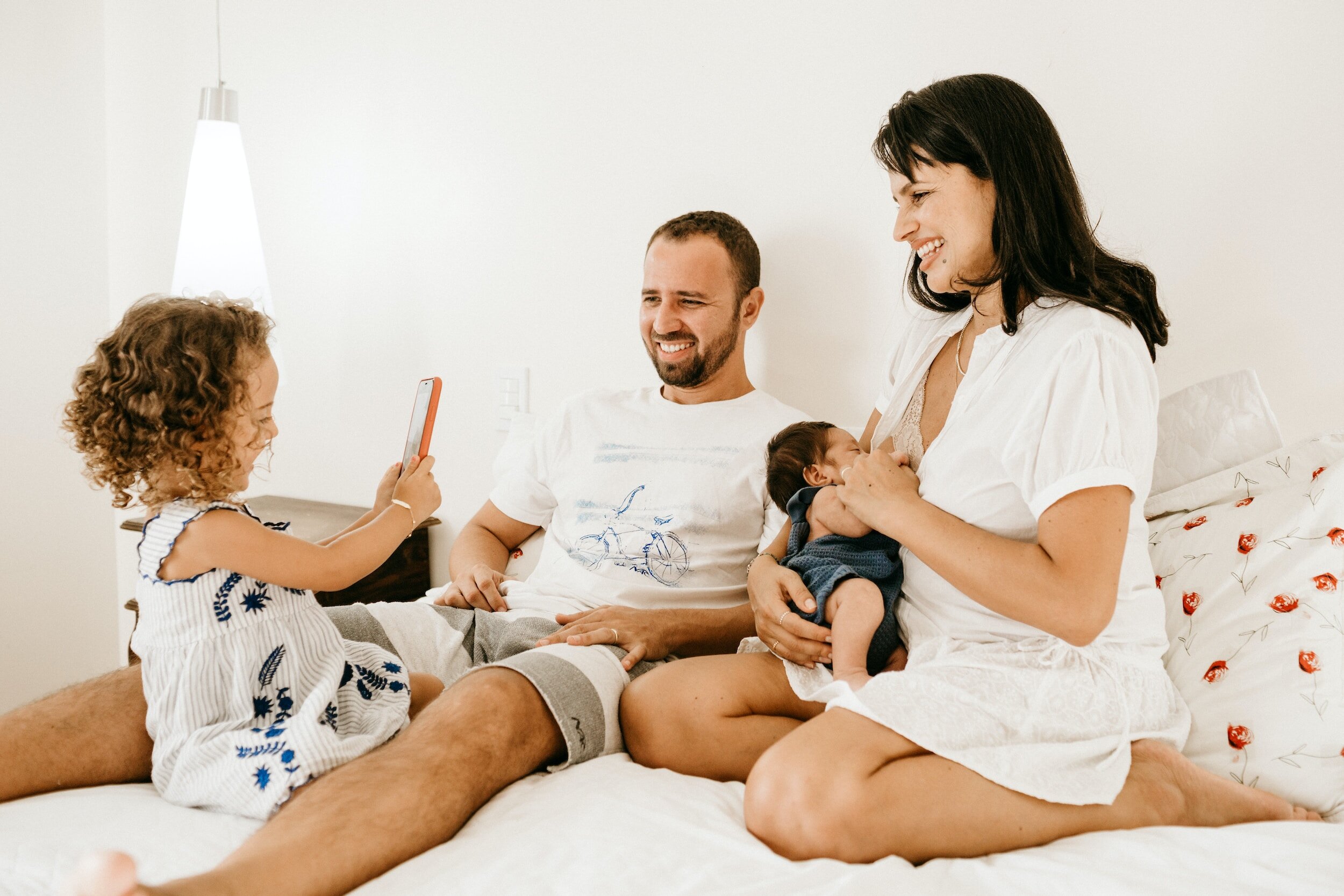 A family of four relaxing together at home, representing the family-centered care at Lake Nona Chiropractic