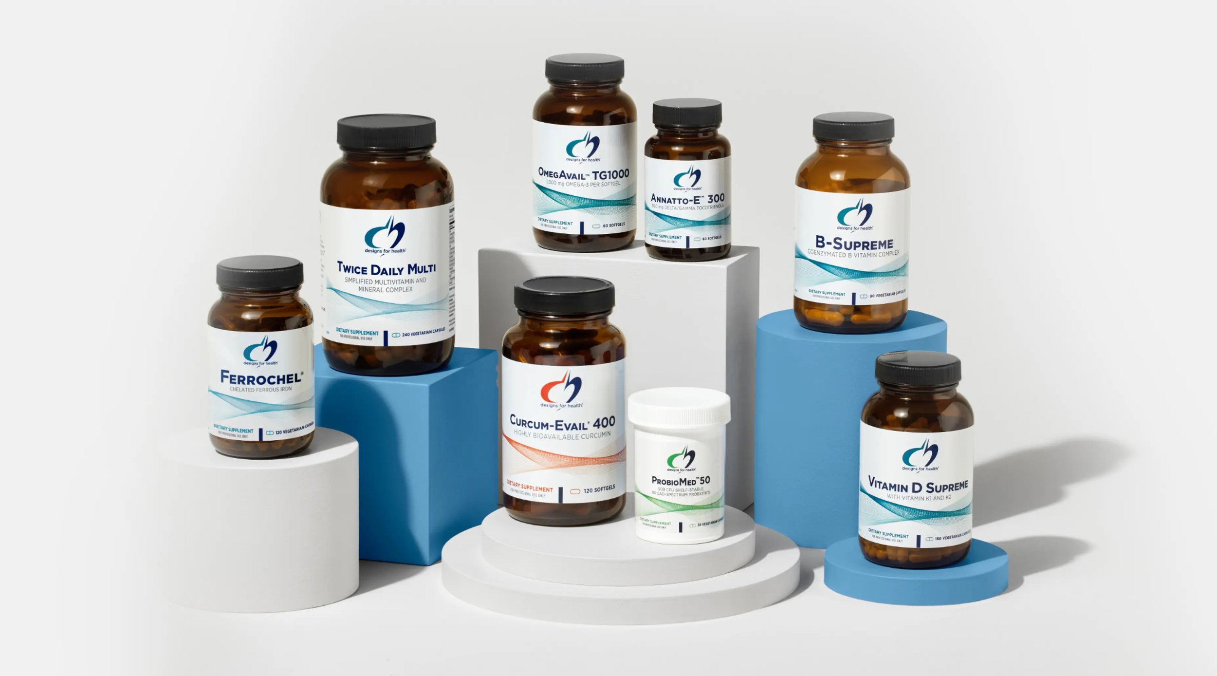 Collection of supplement bottles arranged on decorative blocks, including vitamins and health supplements.