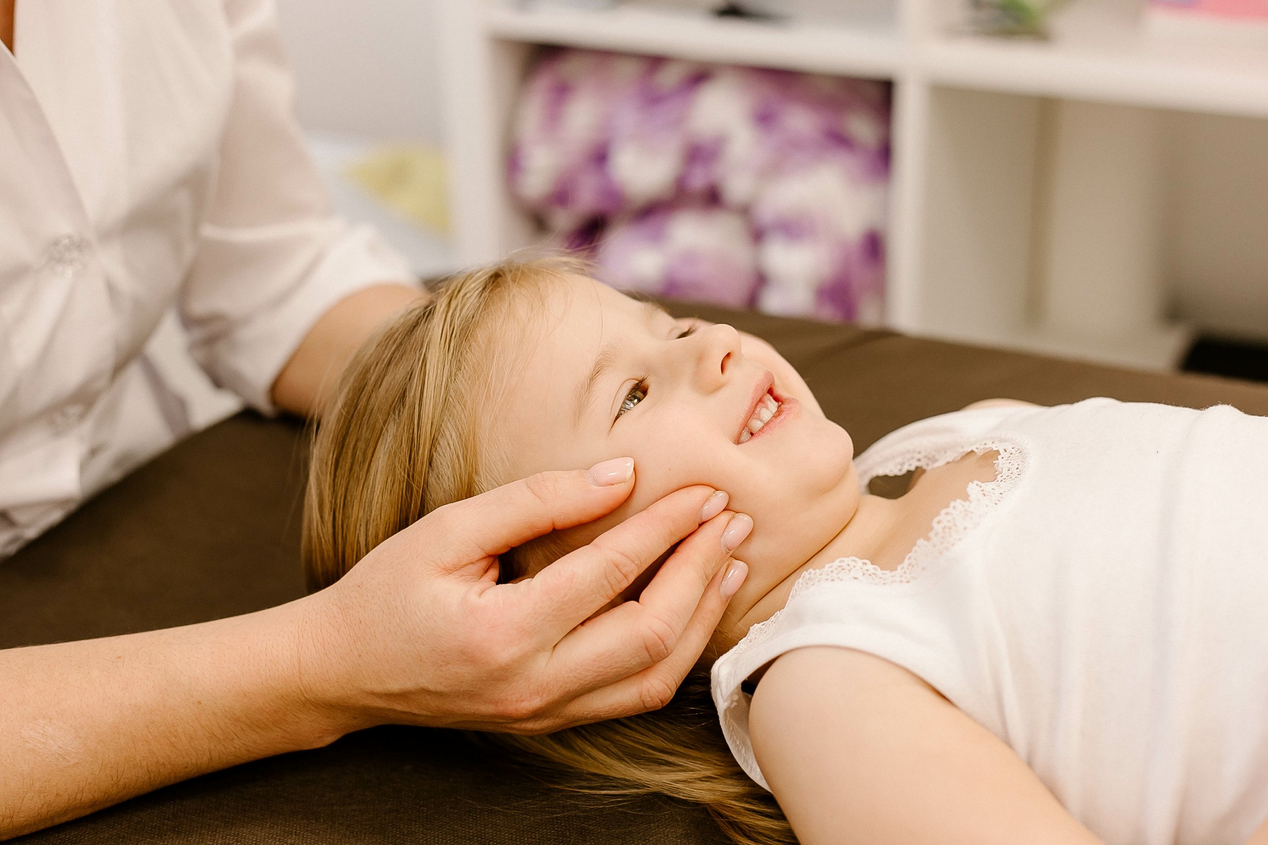 A young child being gently adjusted at Lake Nona Chiropractic