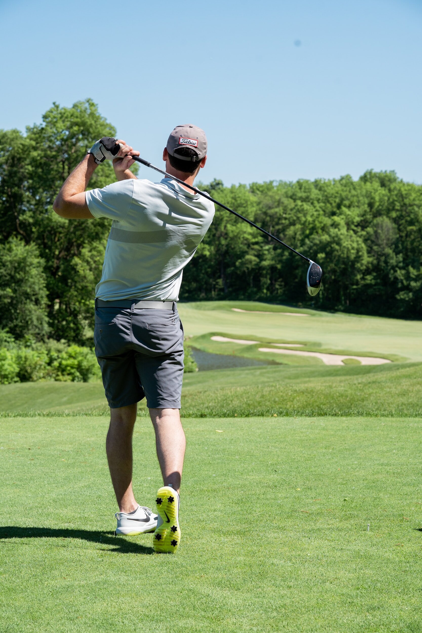 An active person on a golf course, representing the mobility knee pain patients want back