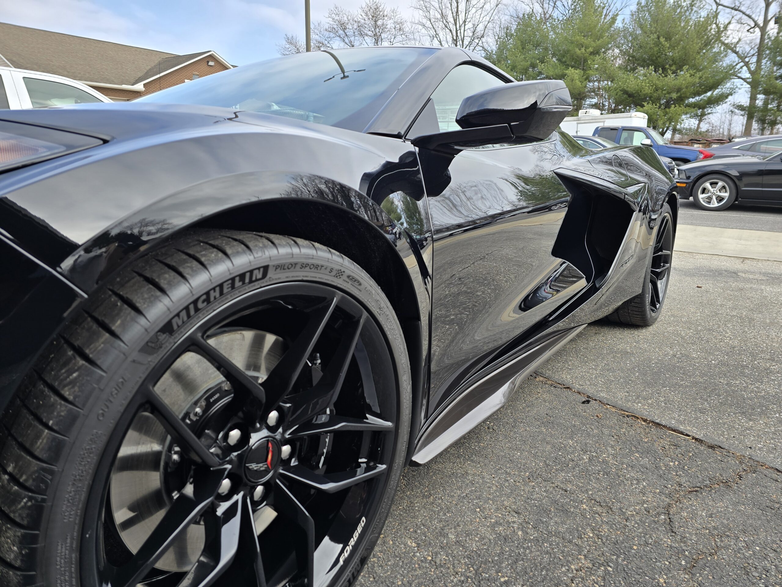 Icon Rocklear coated client vehicle — glossy black sports car with mirror-like finish, Quality Car Detailing Gambrills MD