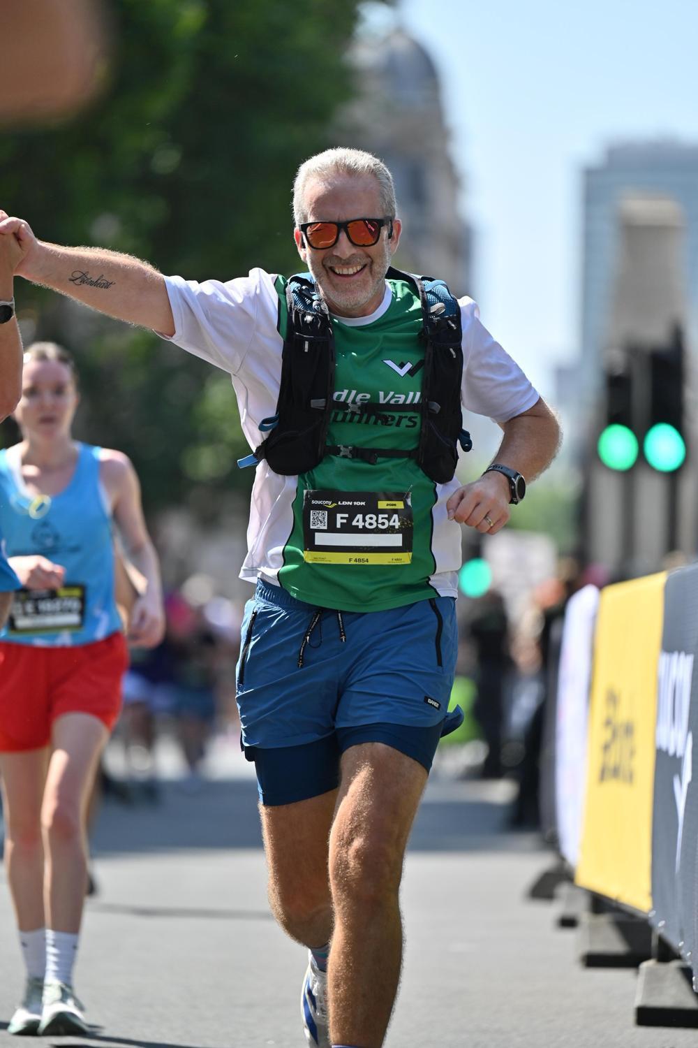Neil arm in the air at a race