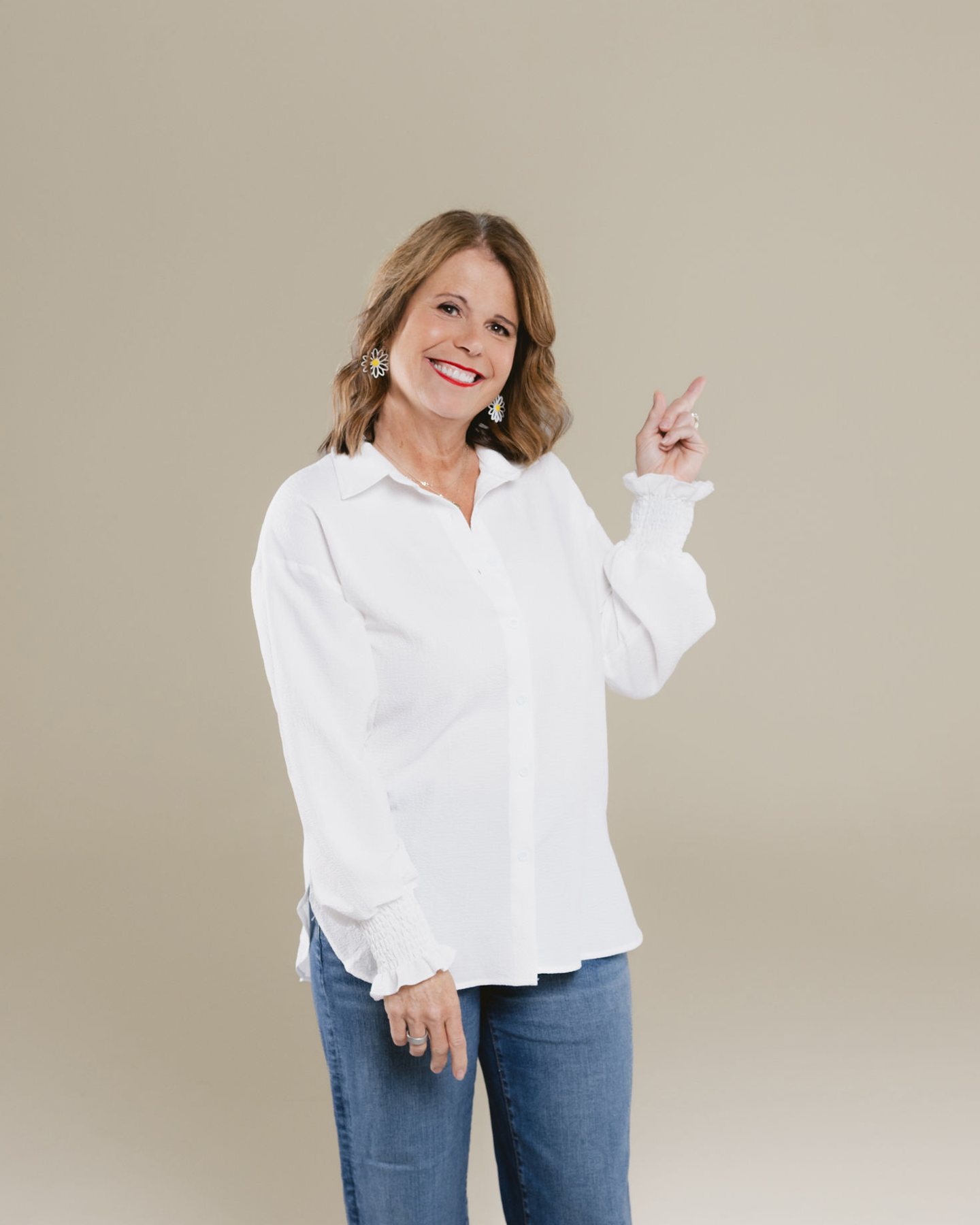 Laura Nelson smiling and pointing toward the waitlist form