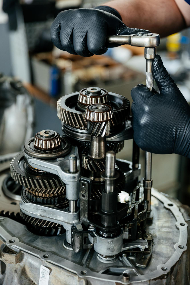 Technician performing precision mechanical work on a drivetrain assembly
