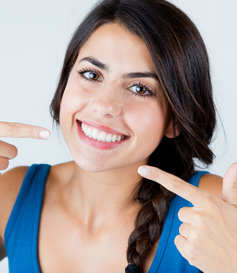 Confident adult smiling after Invisalign treatment
